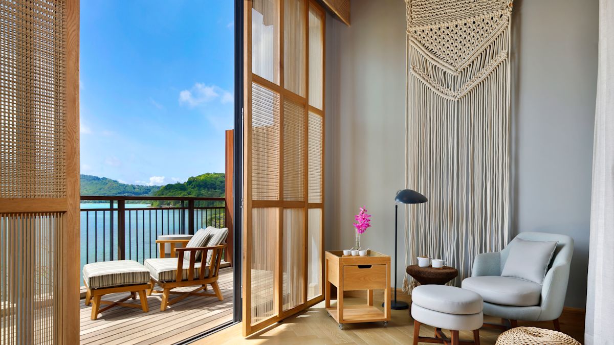 Bedroom with seating and balcony with sun lounger