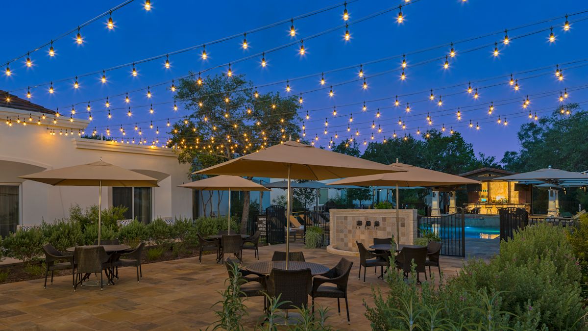 Outdoor seating with umbrellas and string lights