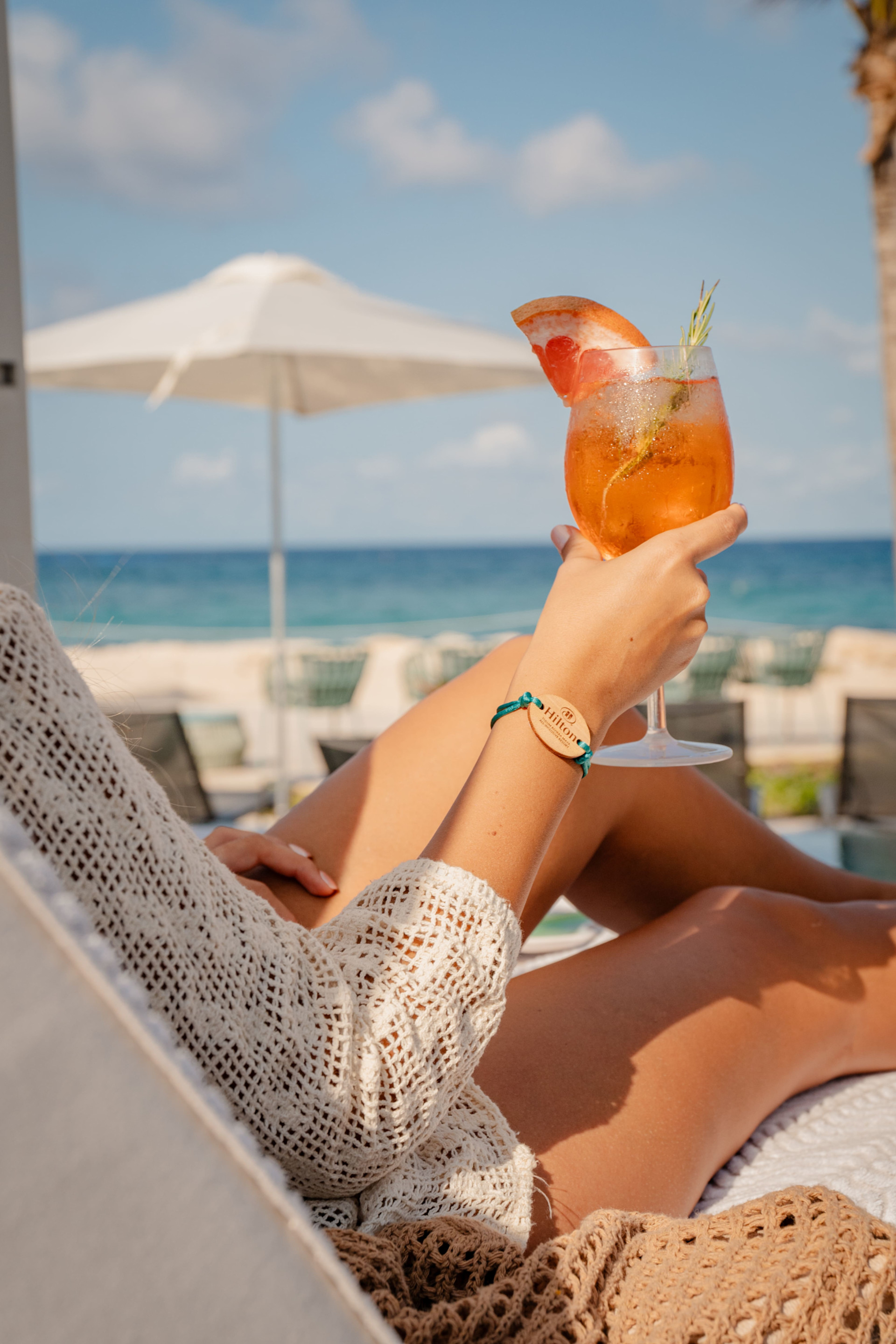 A Woman Enjoying a Cocktail in Pool Area
