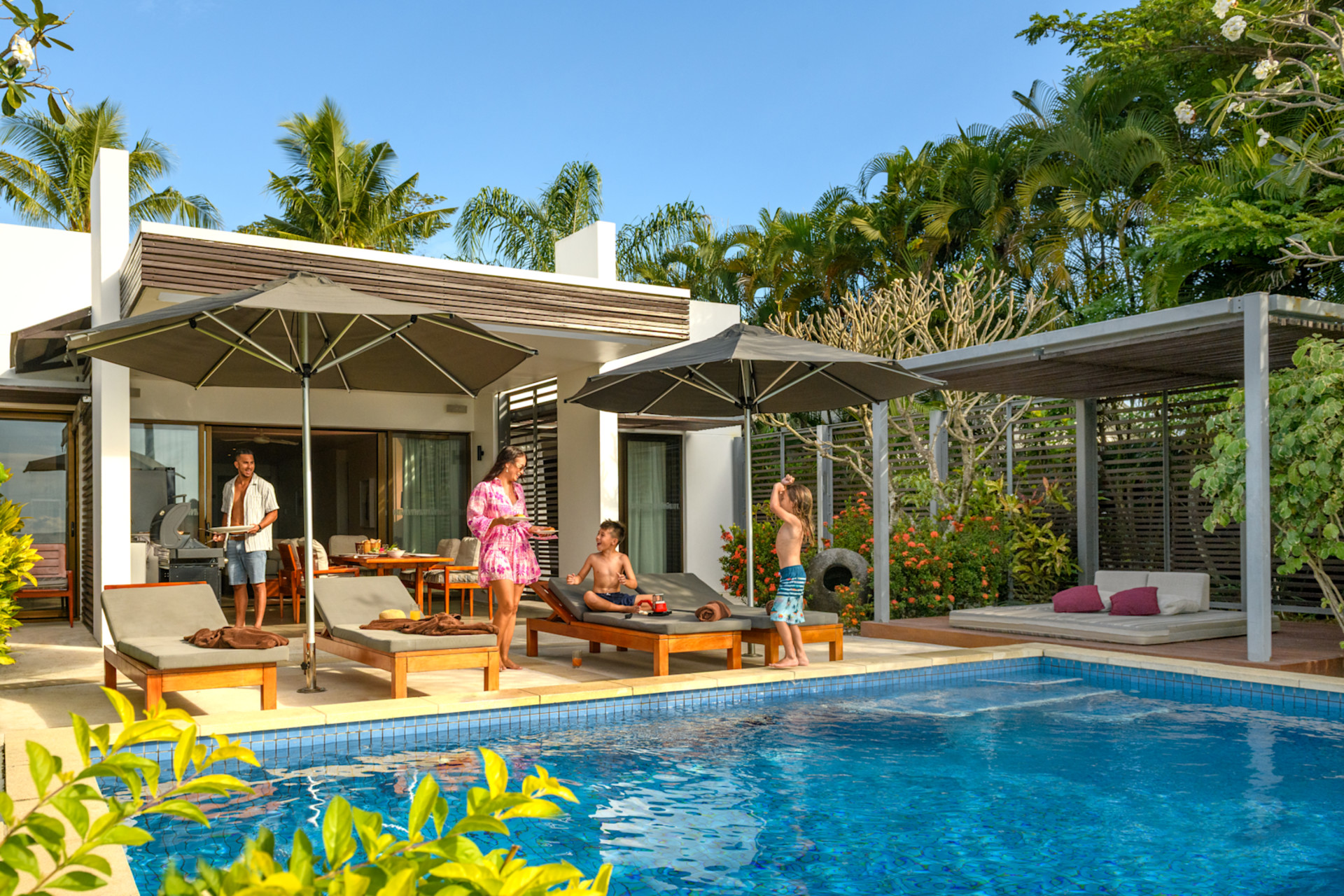 A family playing in their guest room's private pool.