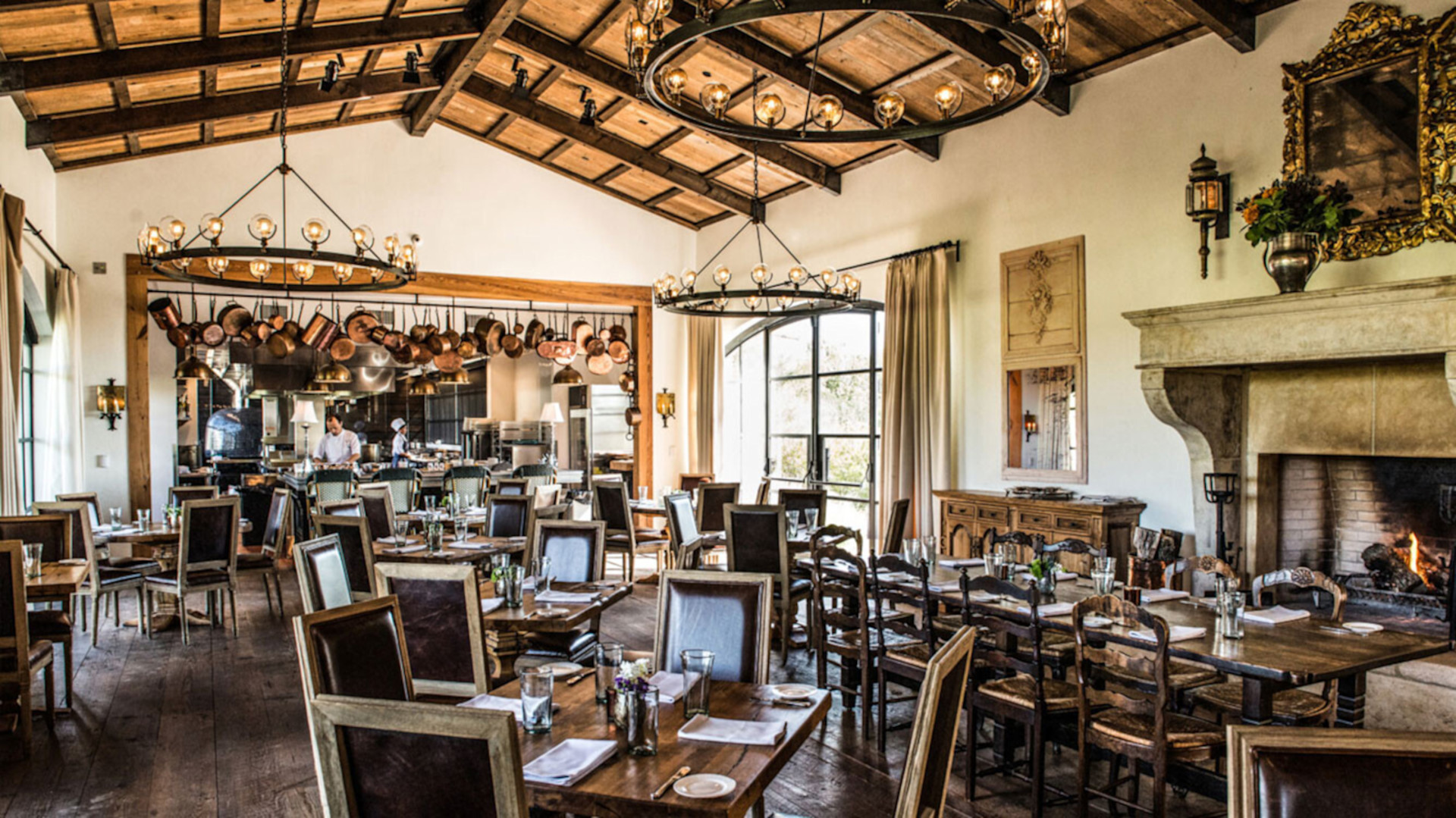 Signature Restaurant seating setup with chef in background preparing