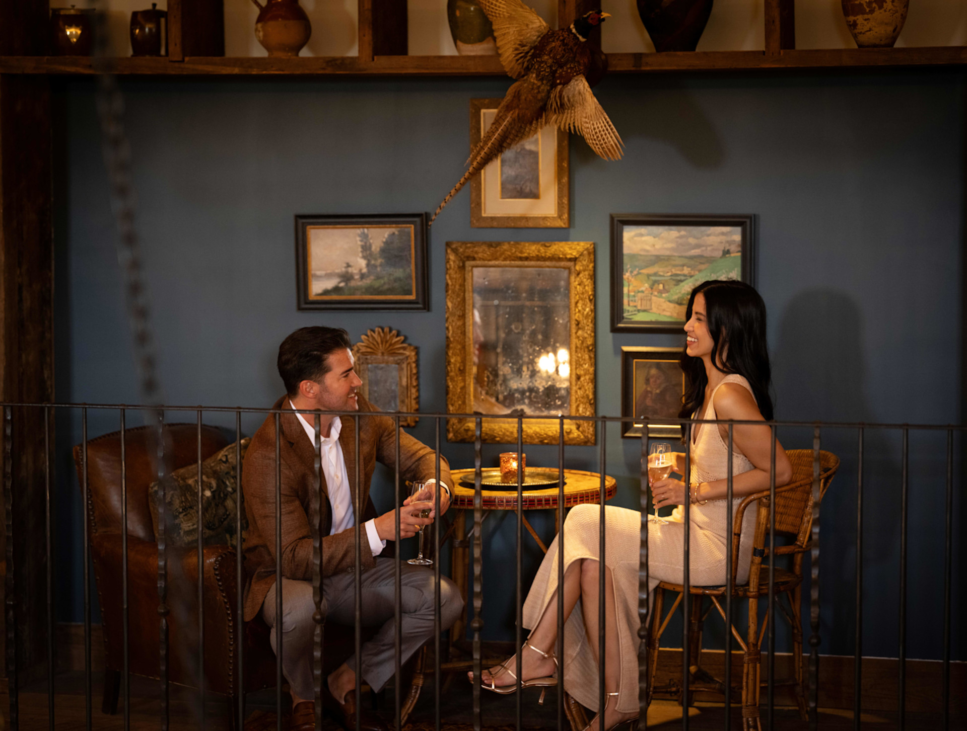 a man and woman sitting together having drinks
