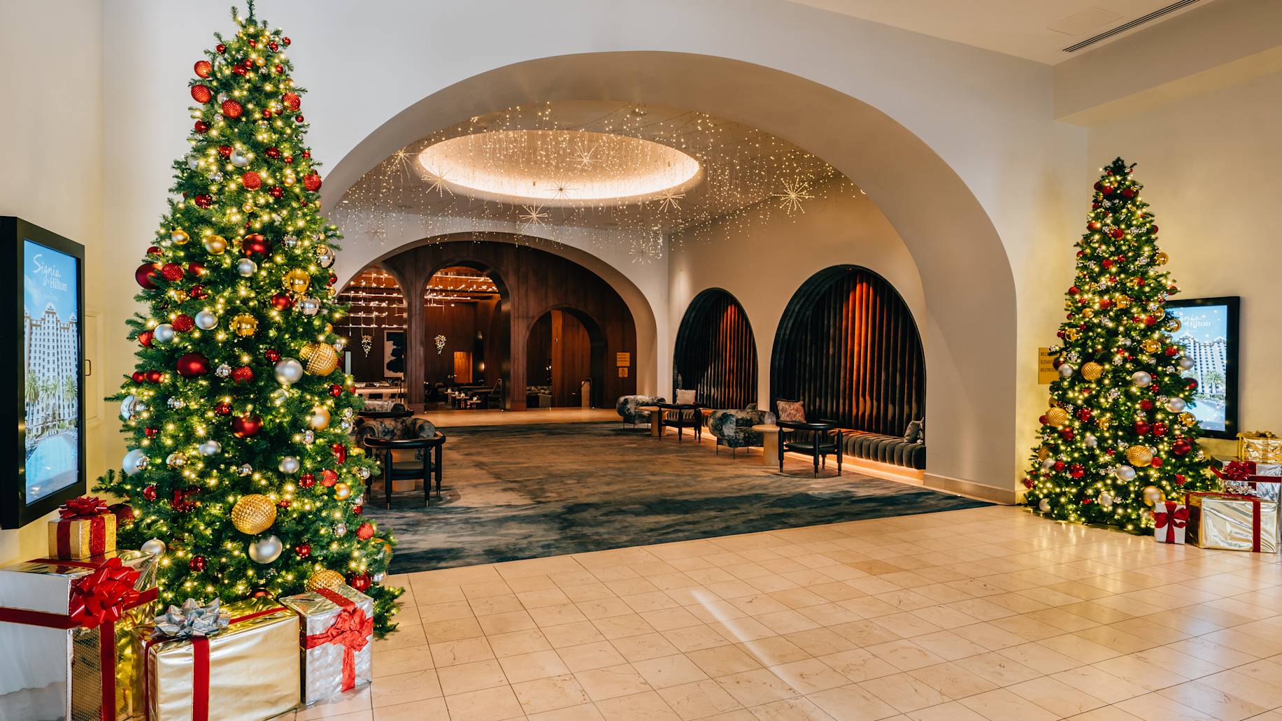 open lobby area decorated with two Christmas trees