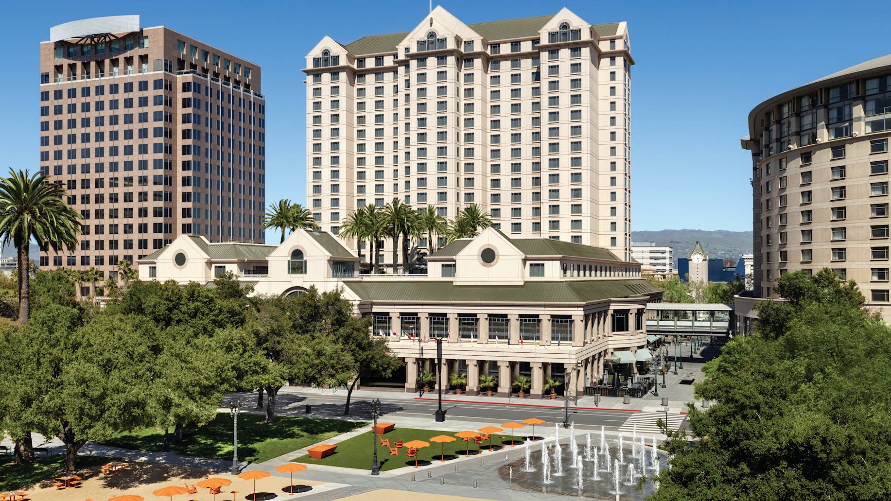 Plaza outside hotel with trees and water features