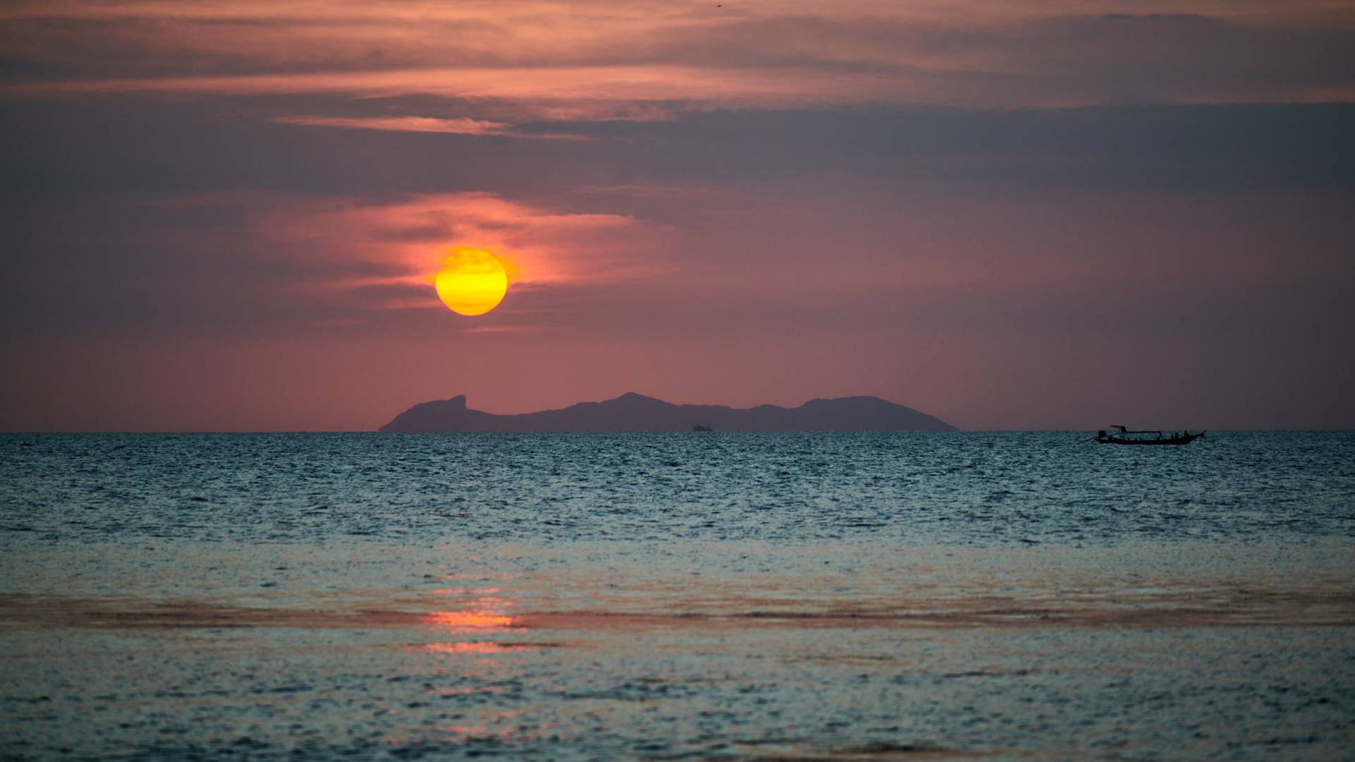 Sunset over the Water with View of Mountains in Background