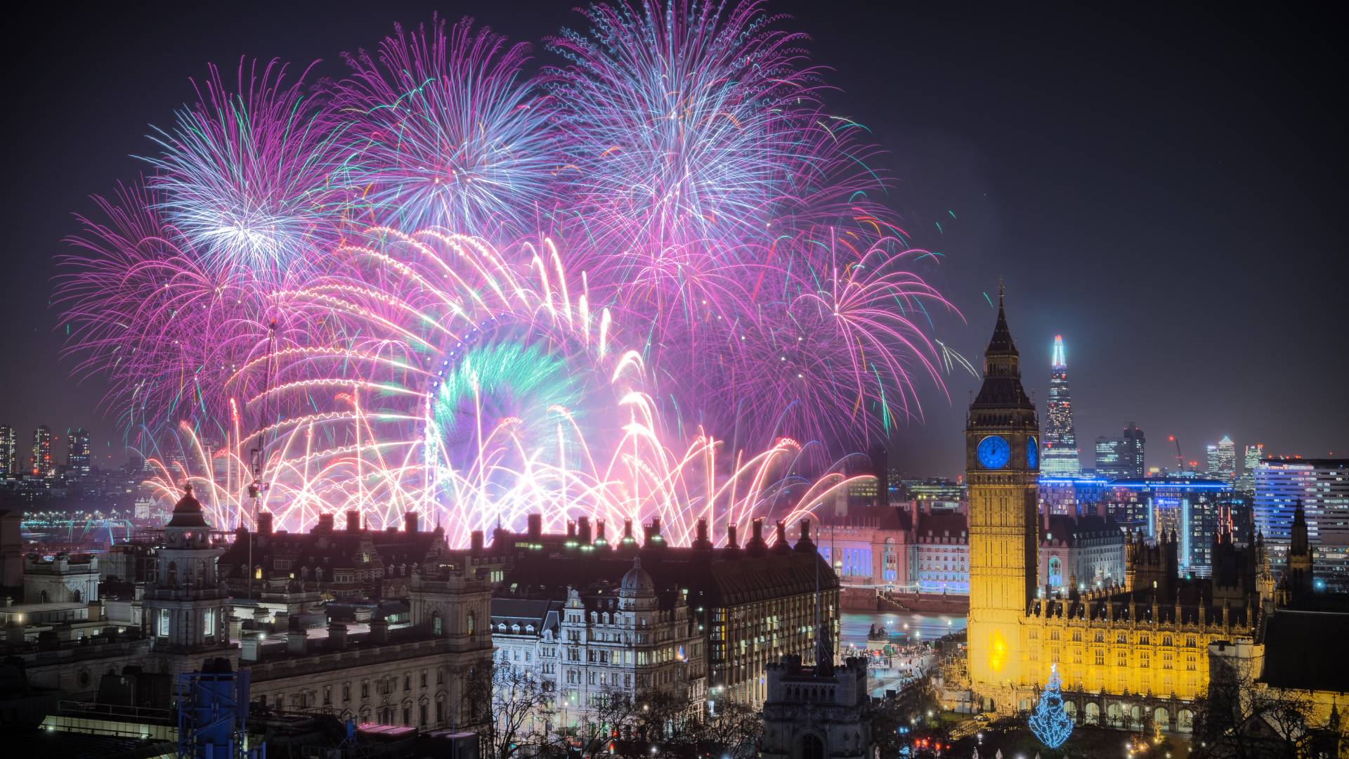 Fireworks exploding in night sky with the Houses of Parliament and Big Ben in the foreground