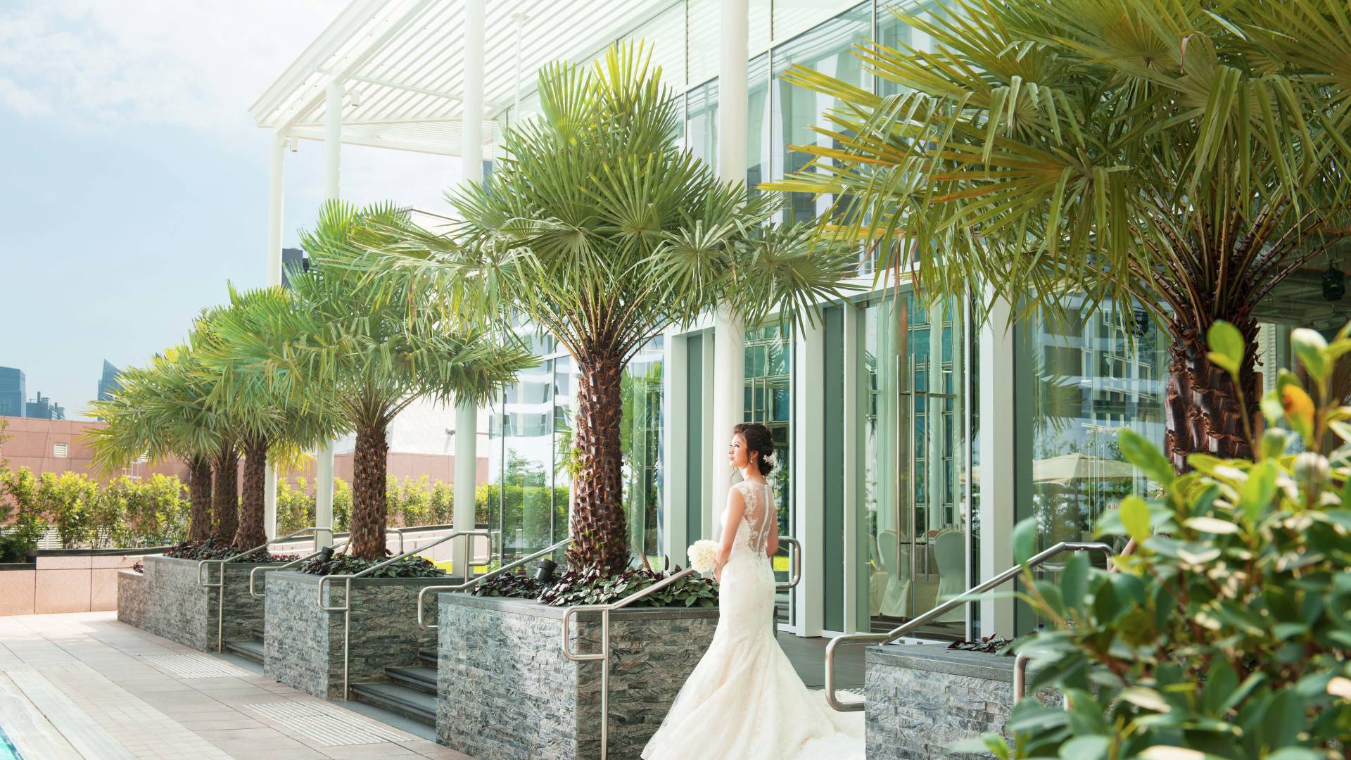 Bride in Wedding Gown on Patio by Outdoor Pool