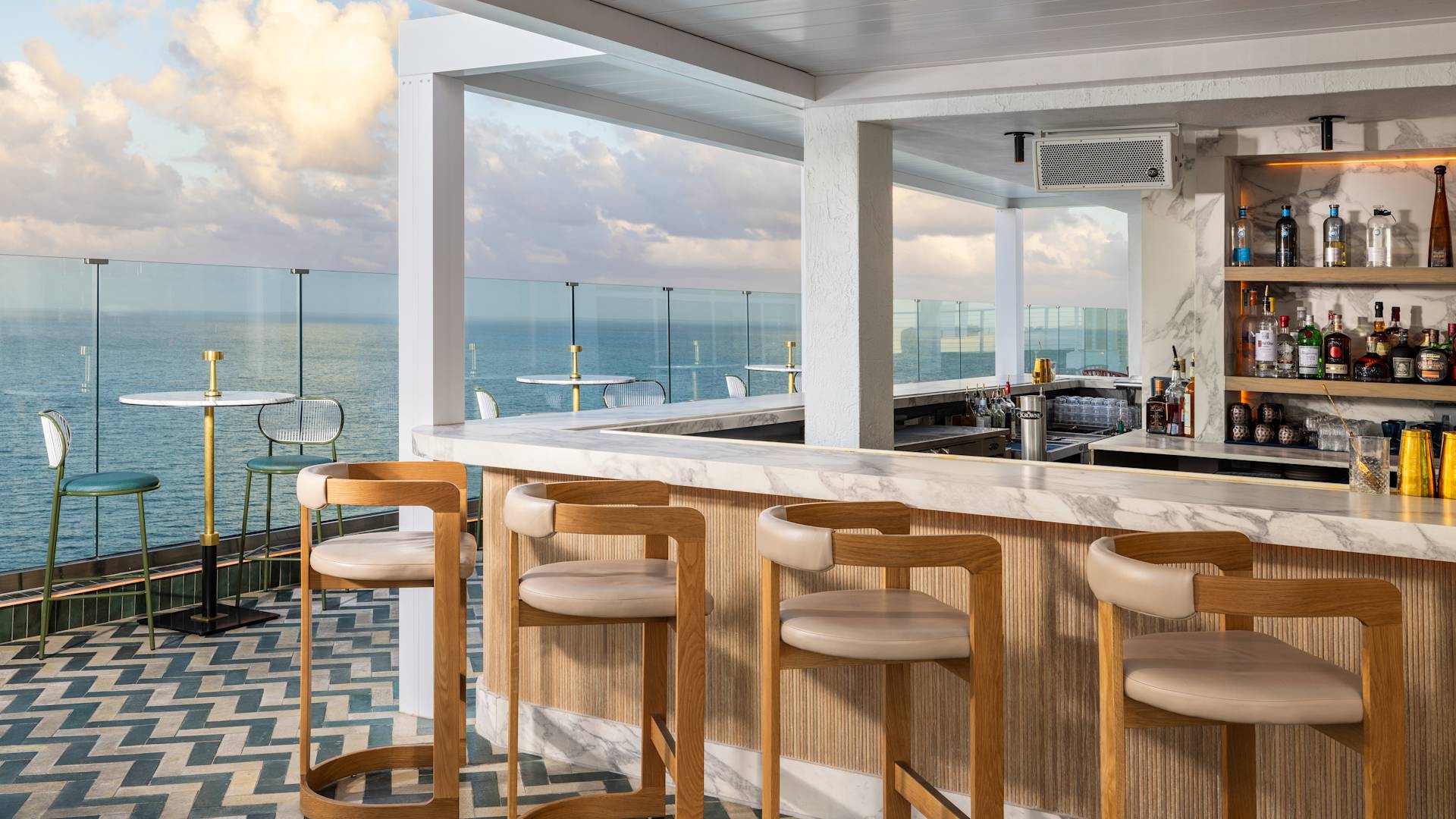 Exterior of Nube's bar with tables overlooking the ocean