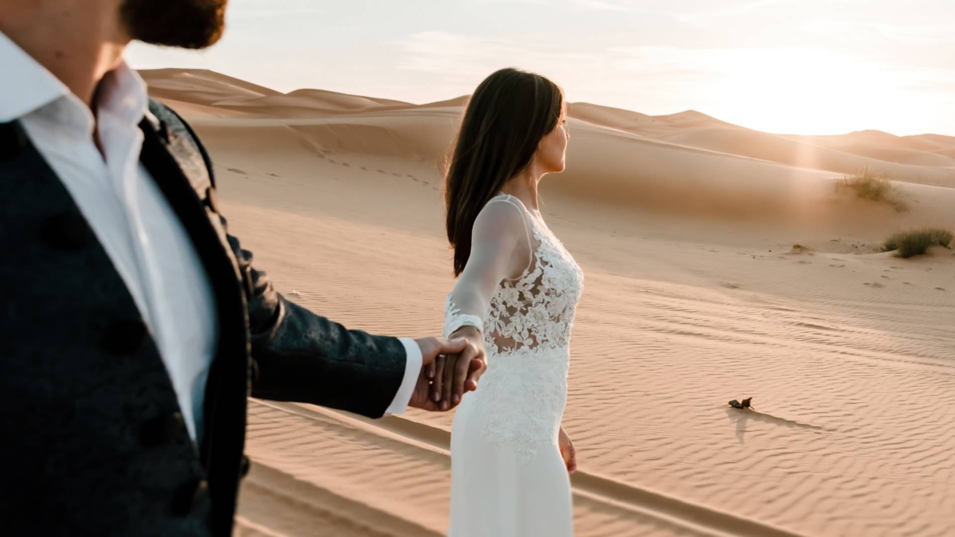 Wedding couple walking on sand