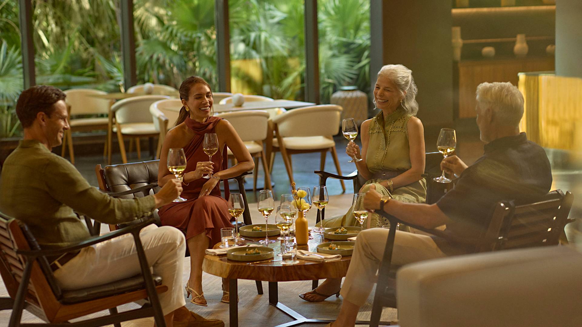 Father, mother and grandparents drinking white wine and enjoying light bites in Ceiba Club