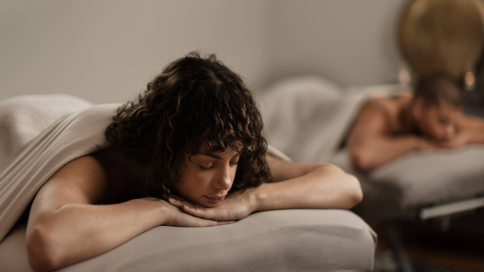 Man and woman relaxing on massage table