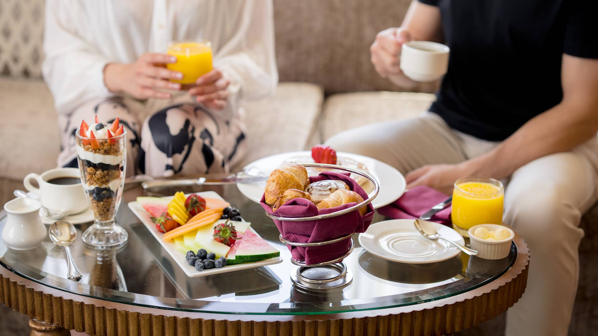 Couple Having Breakfast with a Selection of food, Juice ad Coffee
