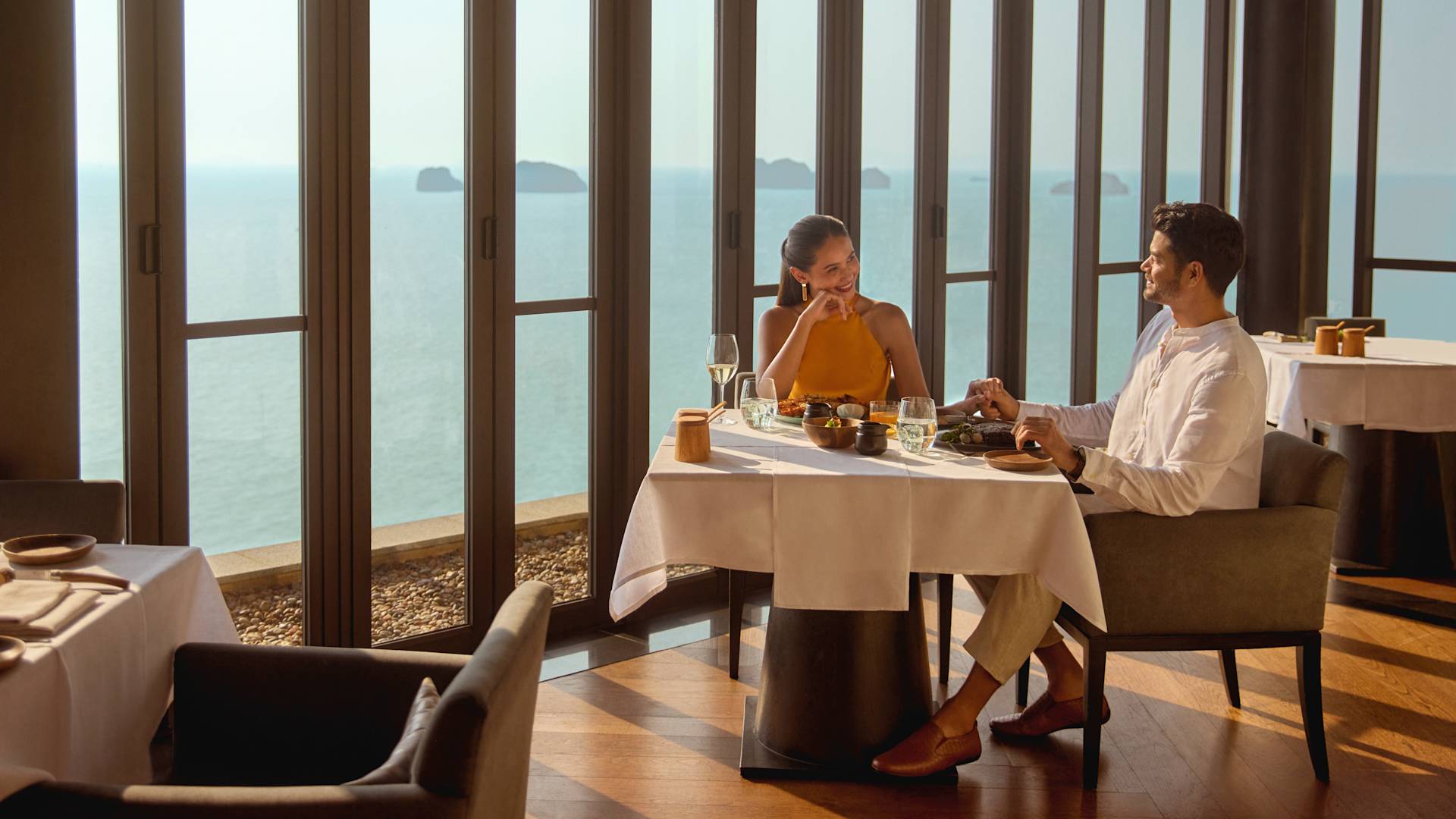 Man and woman sitting at restaurant table with food