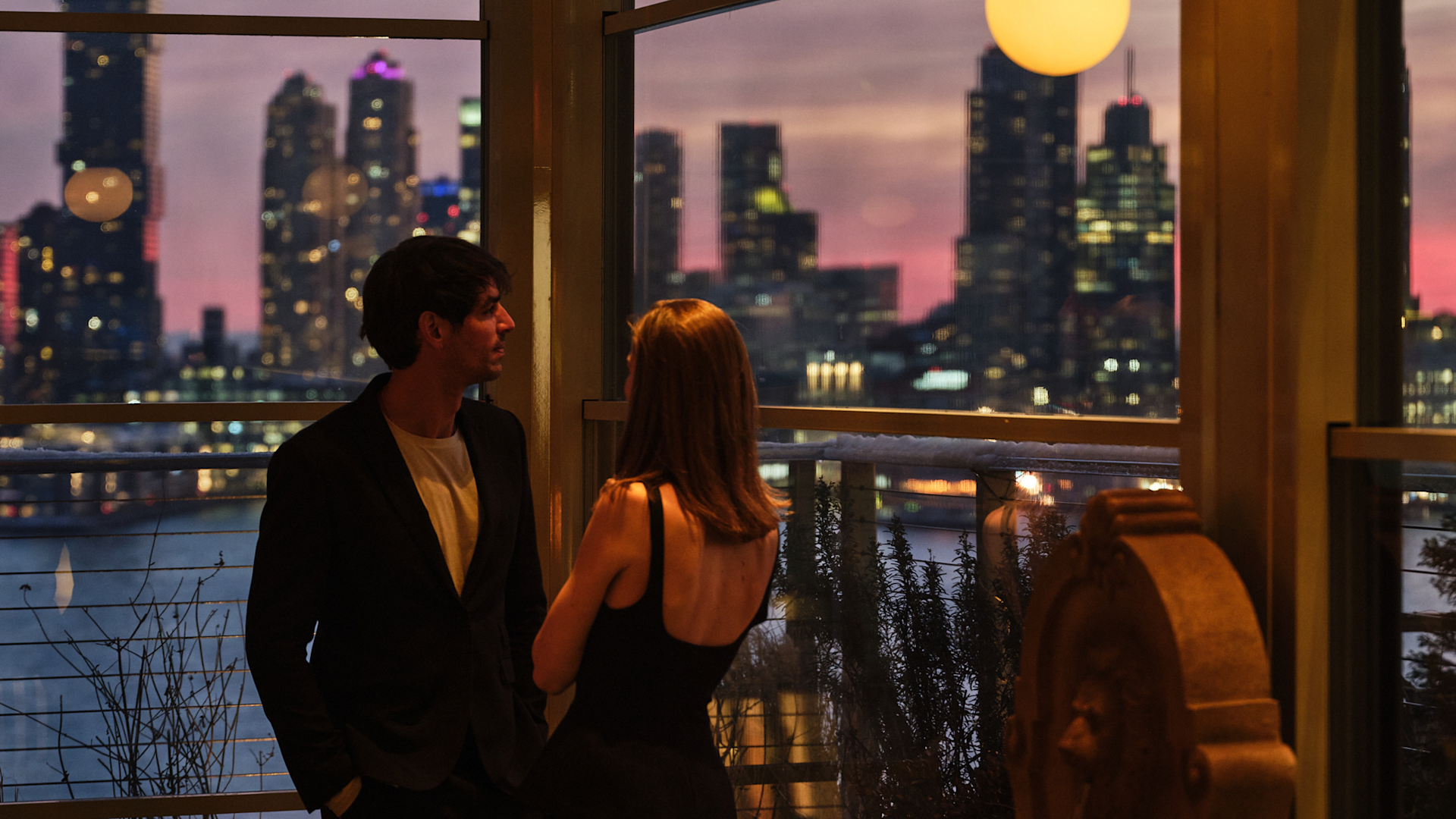 Couple Enjoying Drinks at Leonessa Bar with View of the City at Sunset