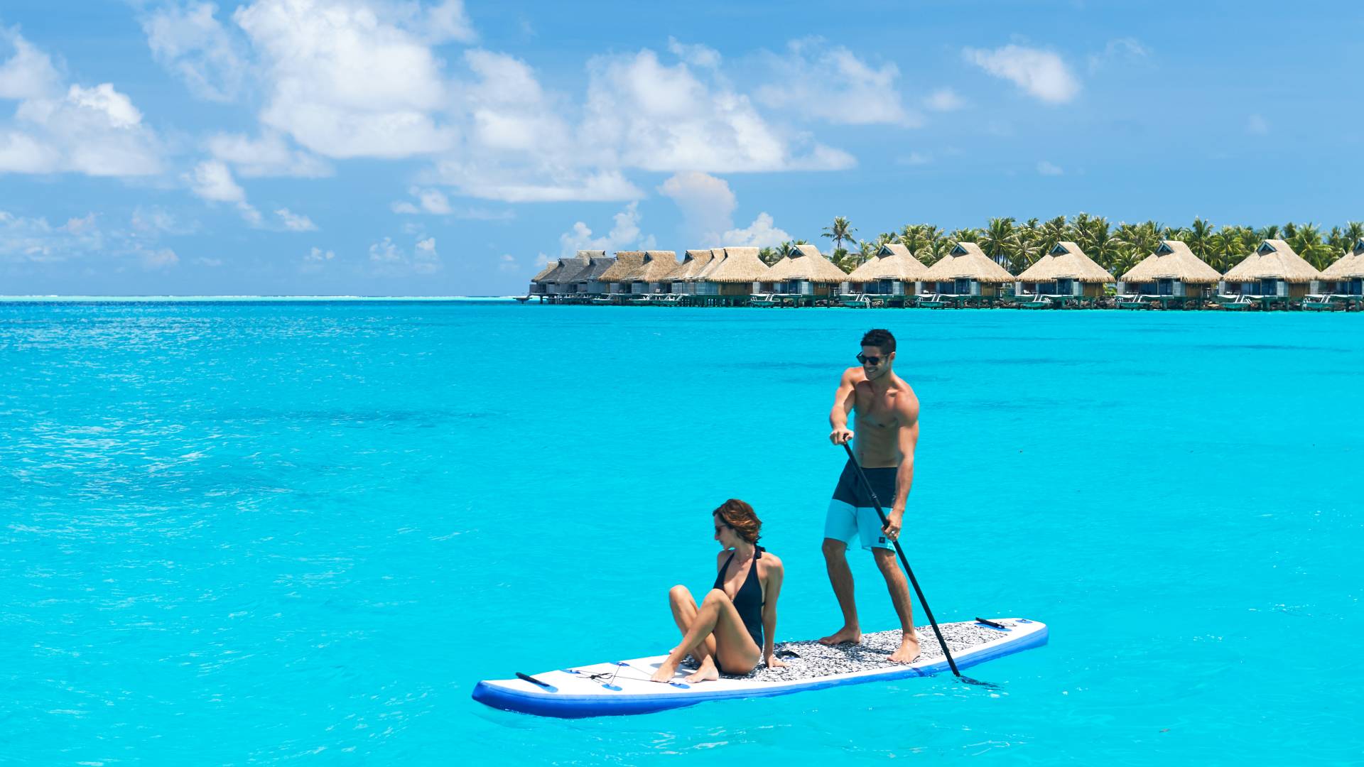 Couple Doing Paddle Board Activity