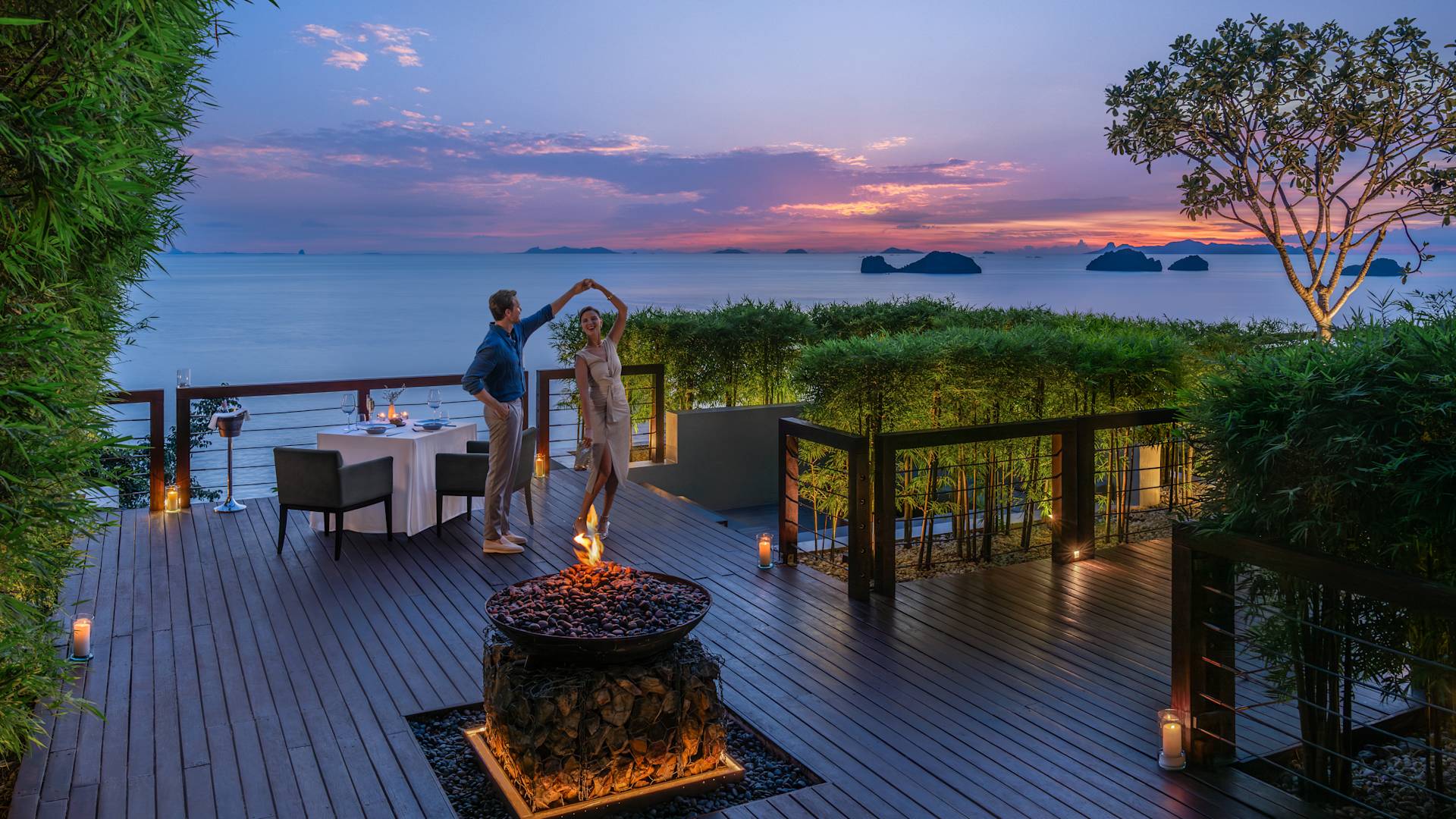 Couple dining and dancing on the terrace of Jahn restaurant at sunset