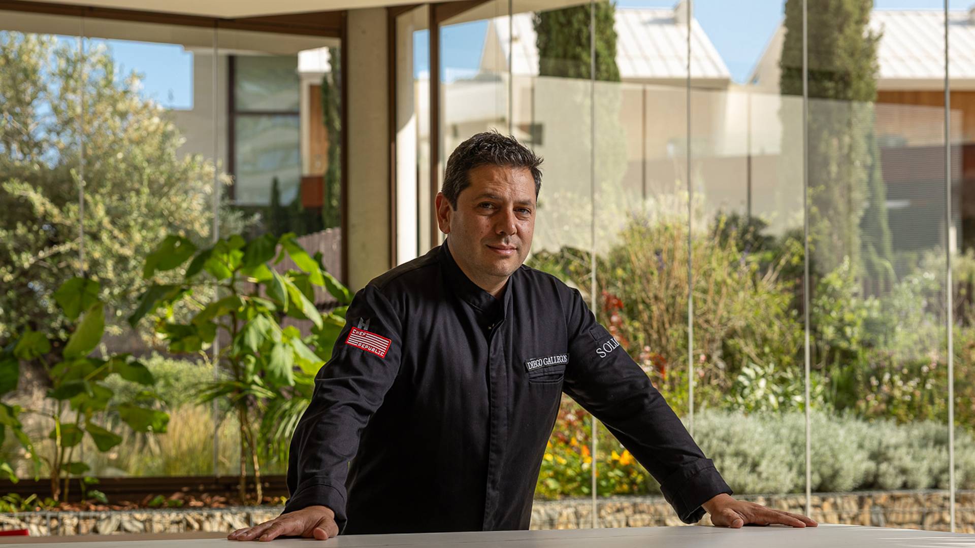 Chef Standing in a Restaurant with Large Windows