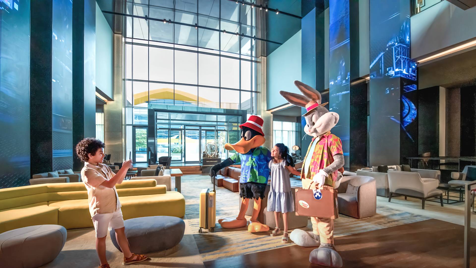 Children posing with bugs bunny and daffy duck