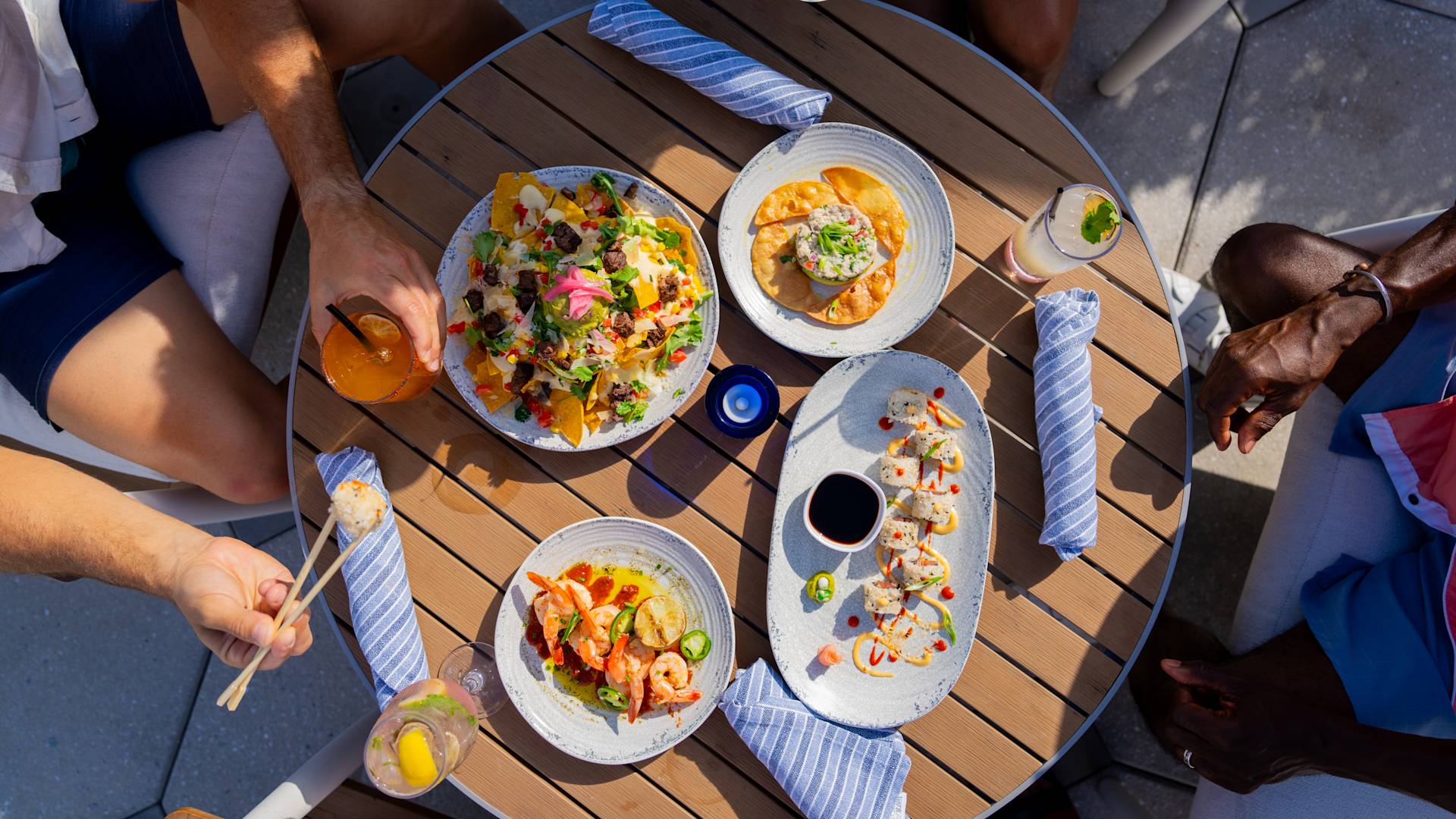 Level Blue food items with people around them aerial shot