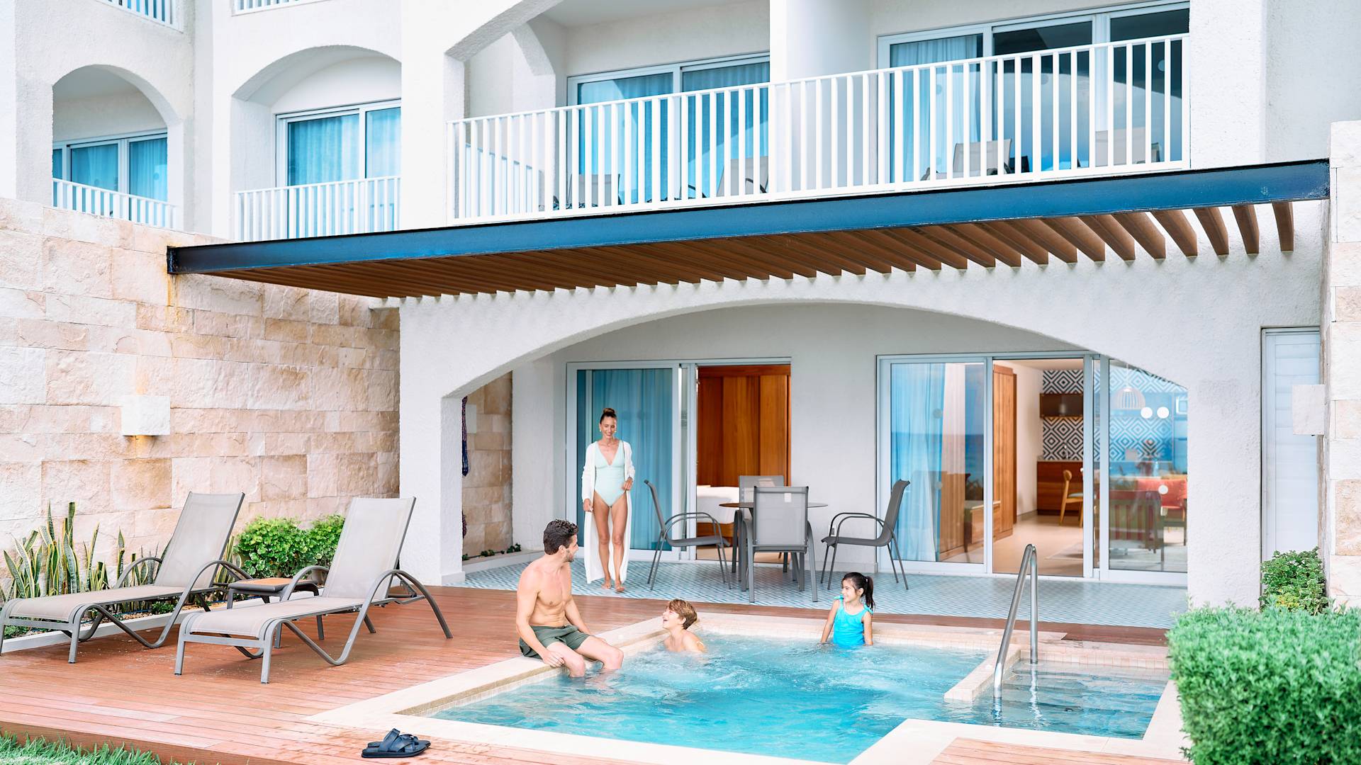 Familie jucându-se într-o piscină cu plonjor din apartament.
