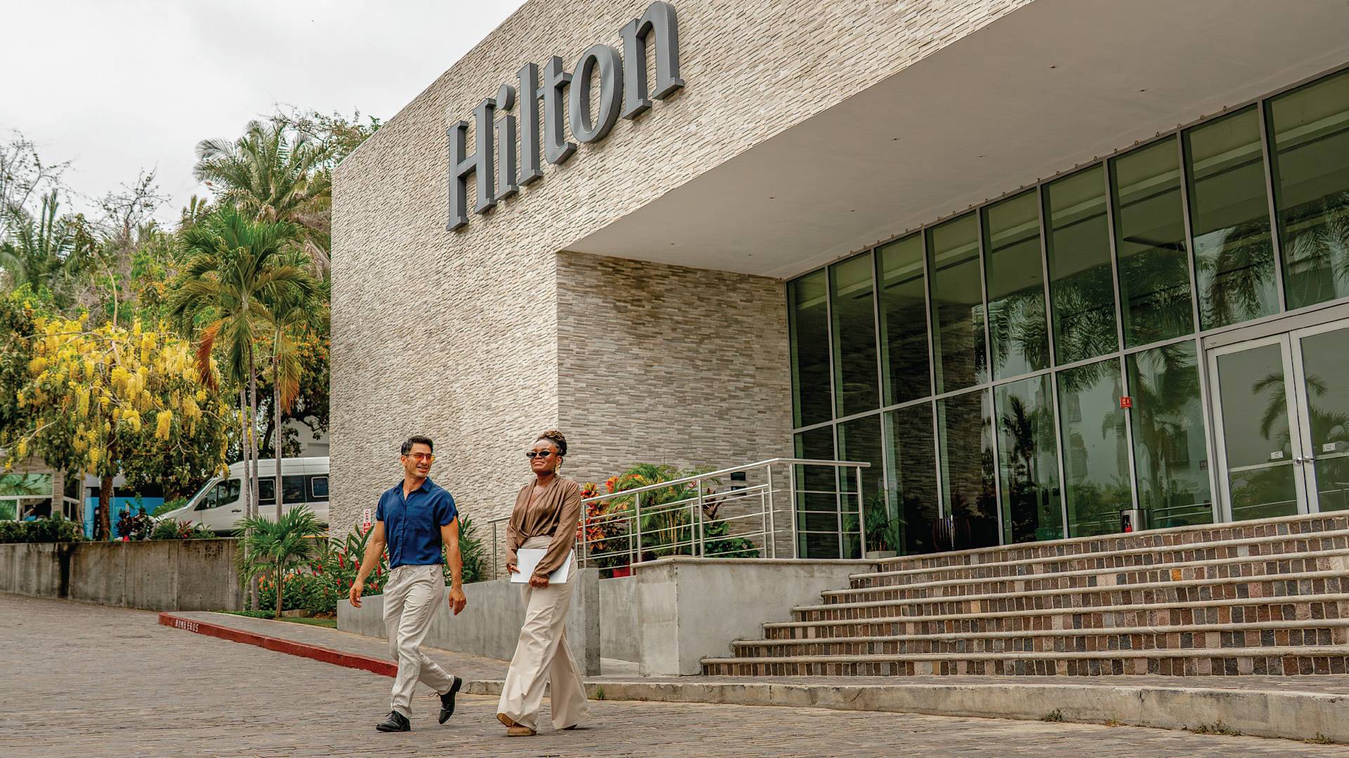 A Man and a Woman are Walking at the Entrance of the Convention Center