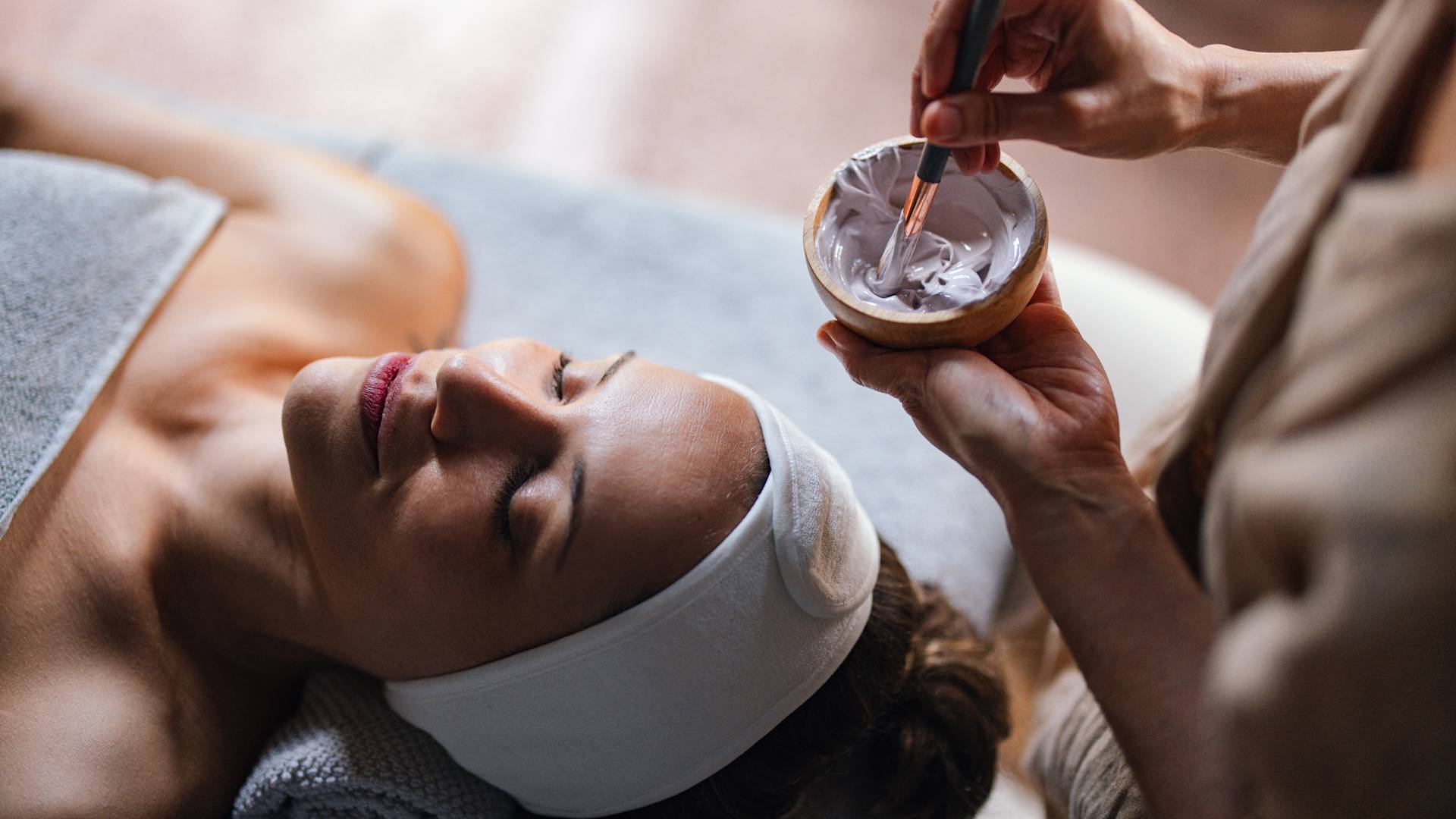 Woman receiving facial treatment at spa