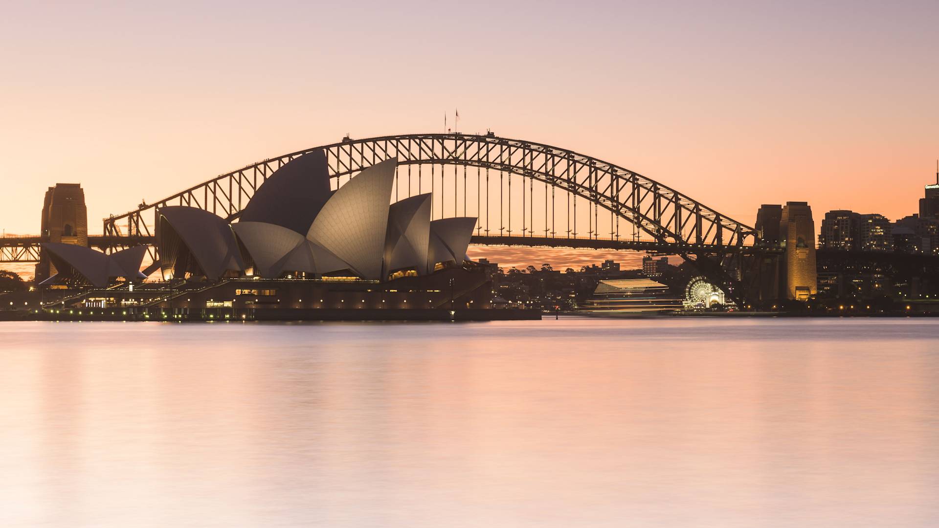 a view of Sydney Harbour Bridge and the Sydney Opera House At dusk