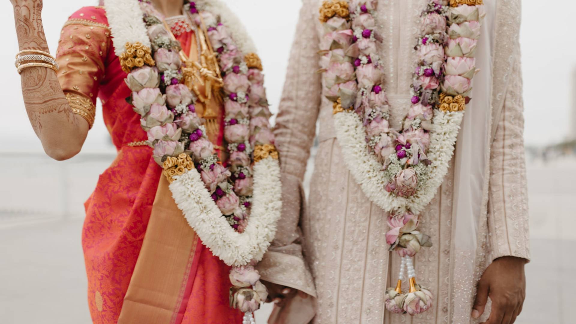 Wedding ceremony featuring bridge and groom participating in outdoor ceremony