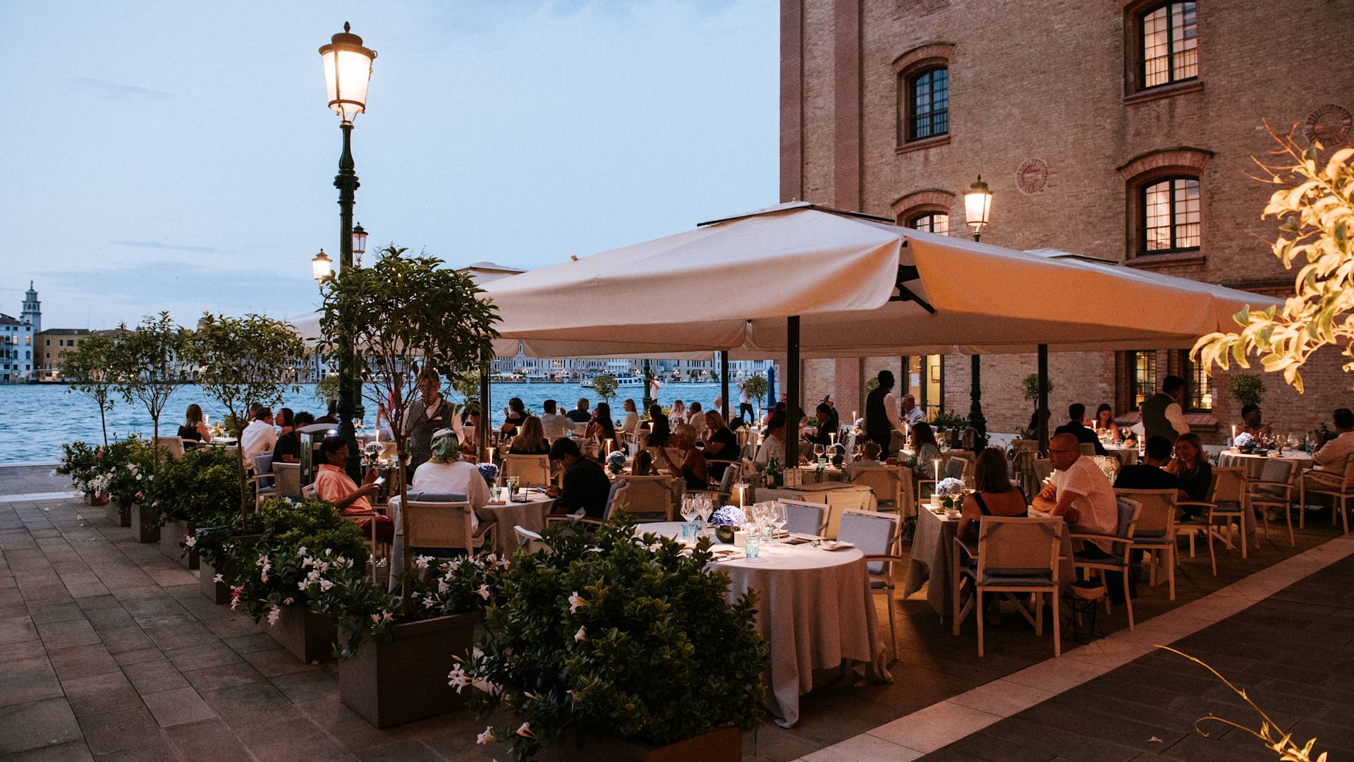a Group of People on a Dining on the Terrace of a Restaurant with Water View