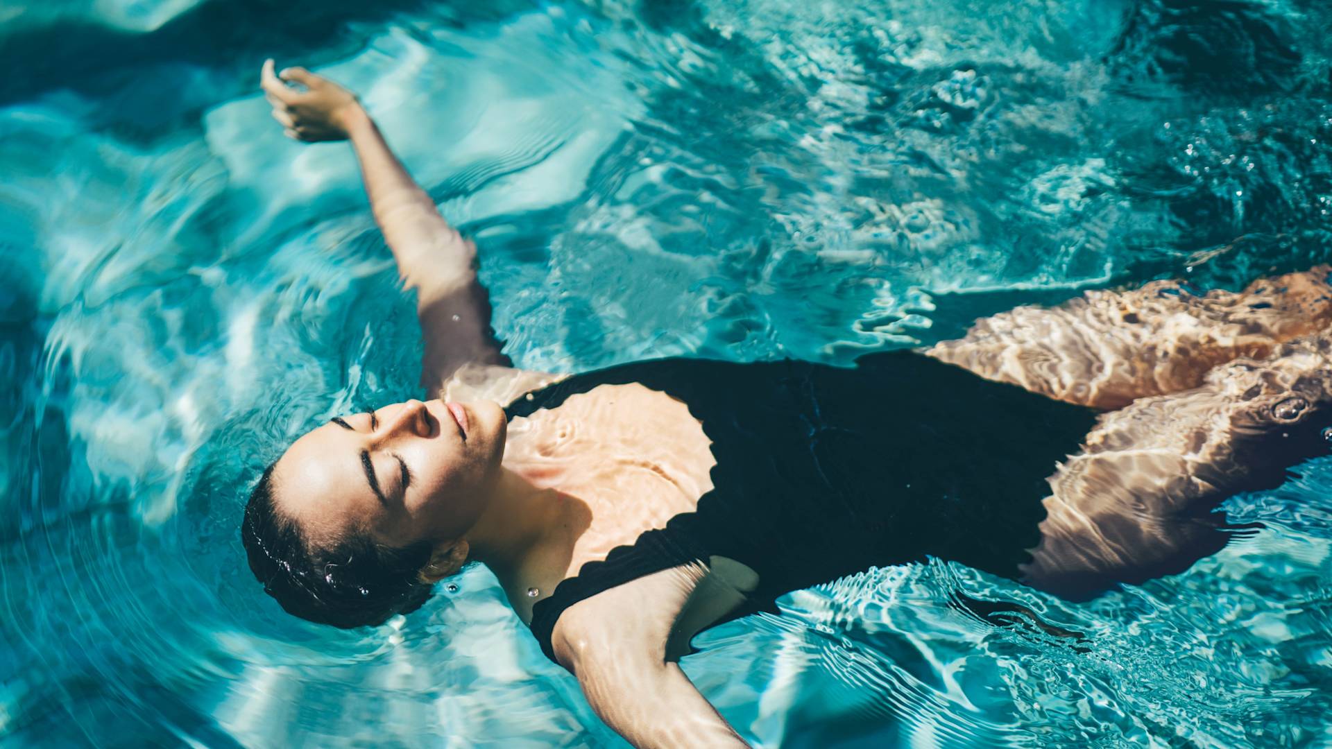 Woman floating in pool