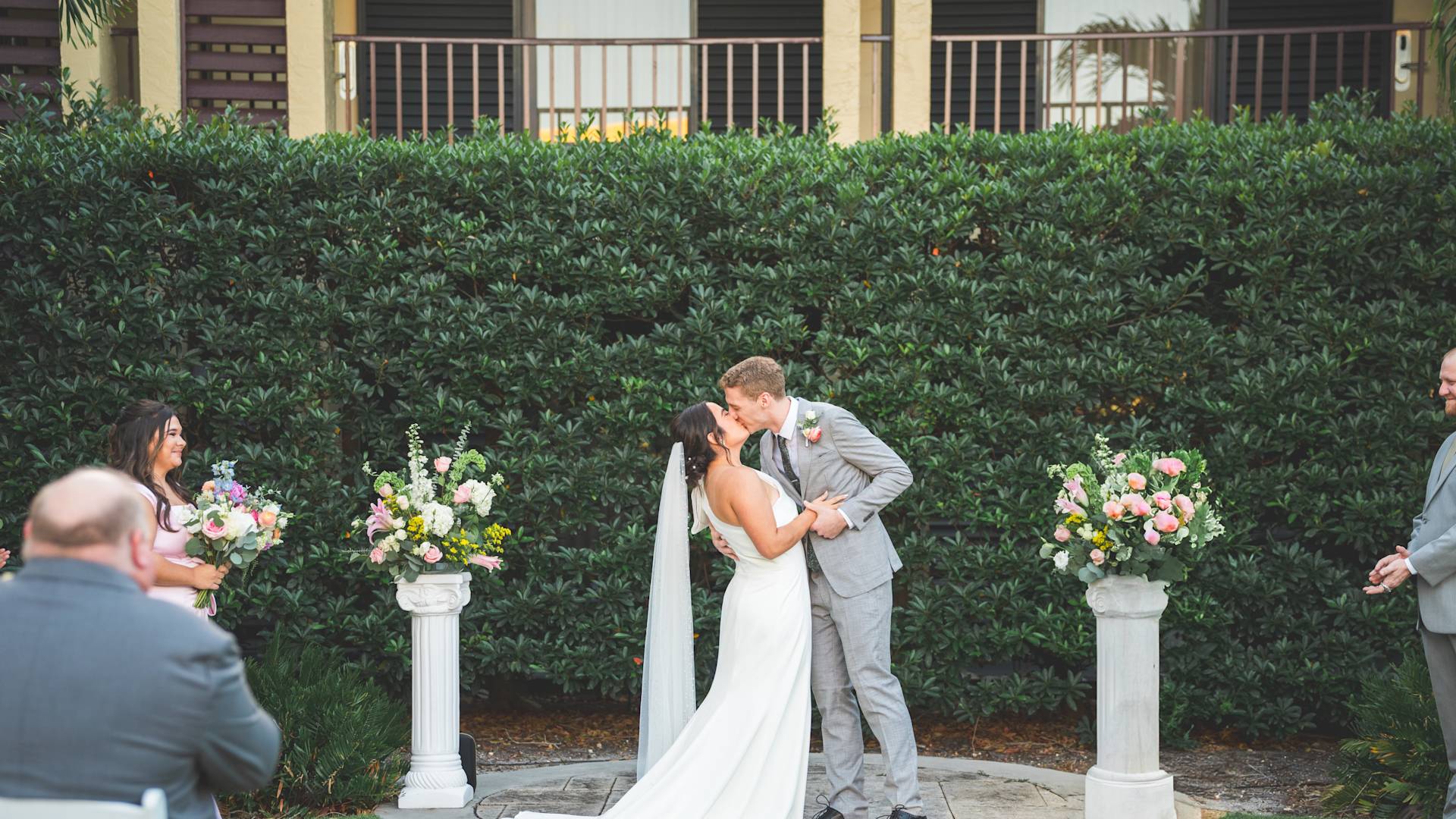Couple Kissing in a Garden on Their Wedding Day