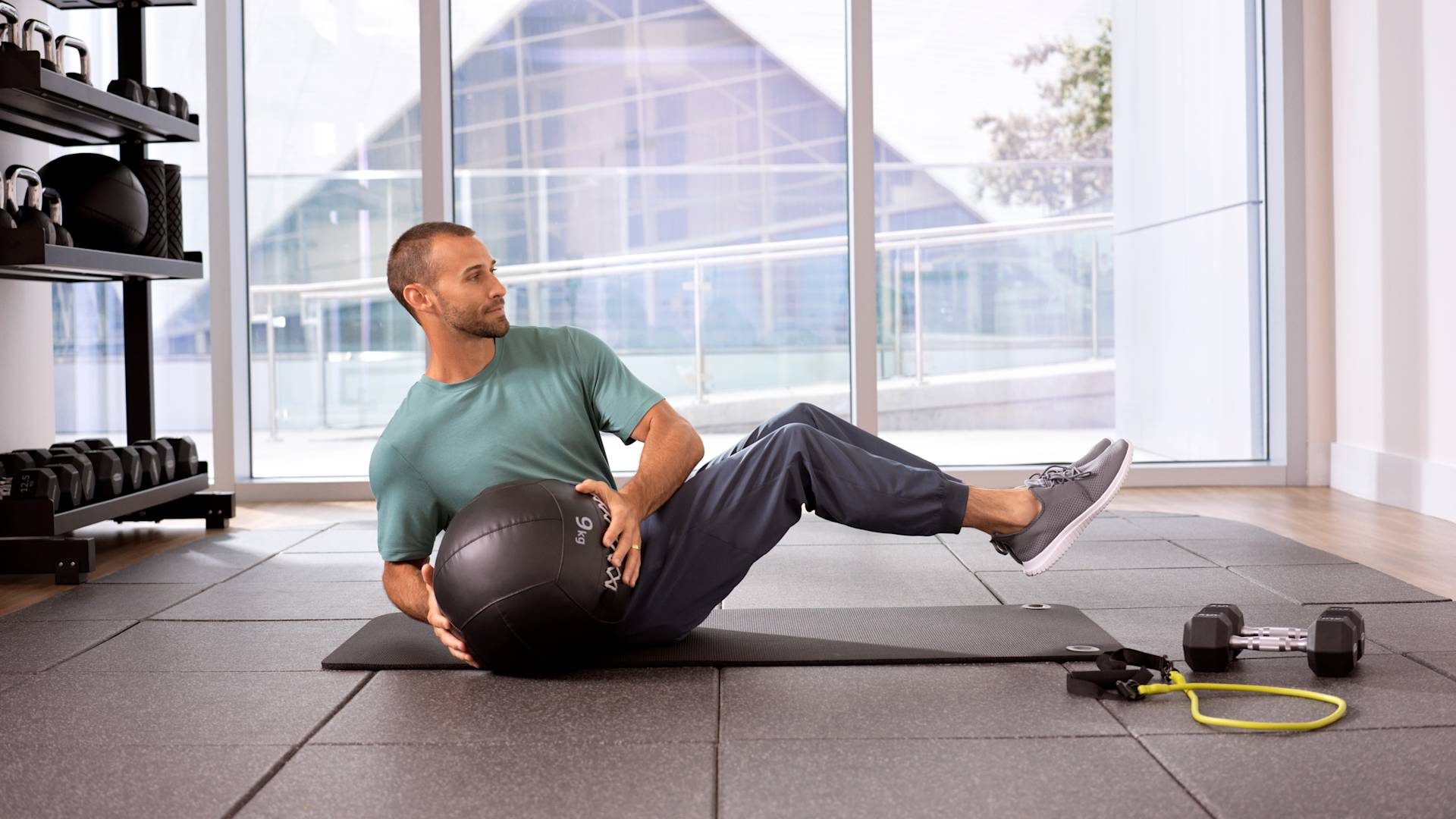 Man exercising with medicine ball on mat