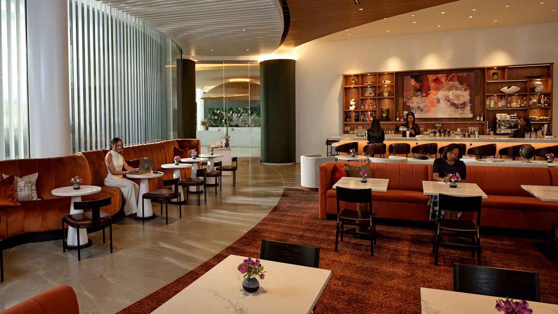 Spacious seating area with customers and staff around bar area