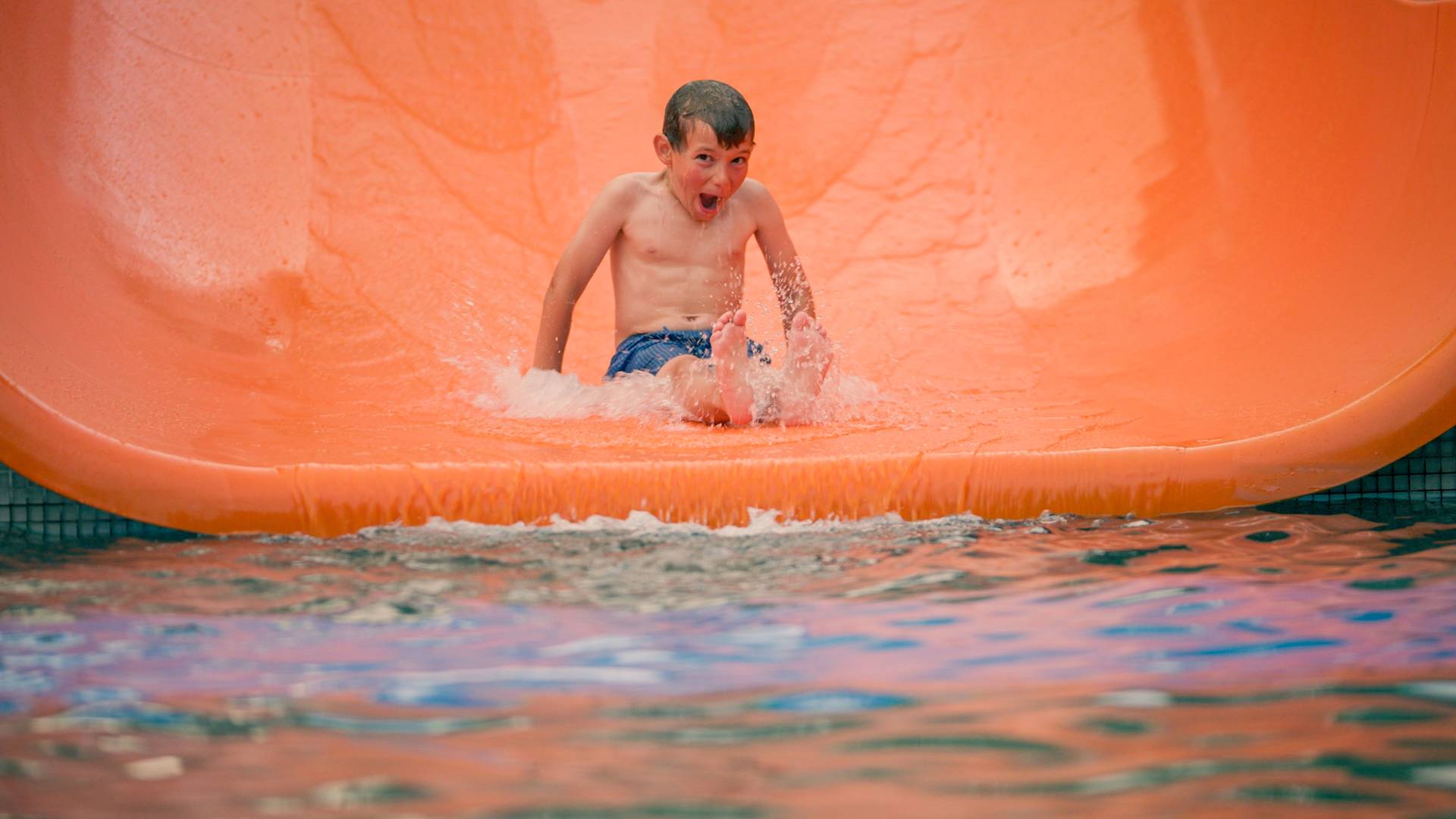 Kid sliding on water slide