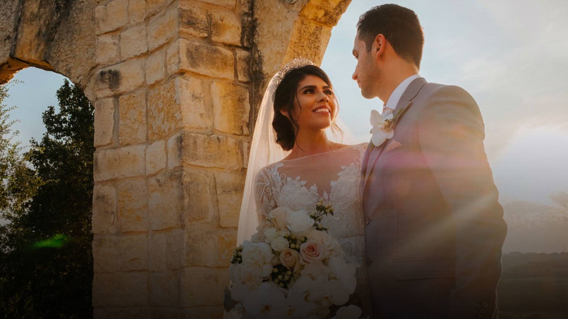 Wedding couple under stone arch