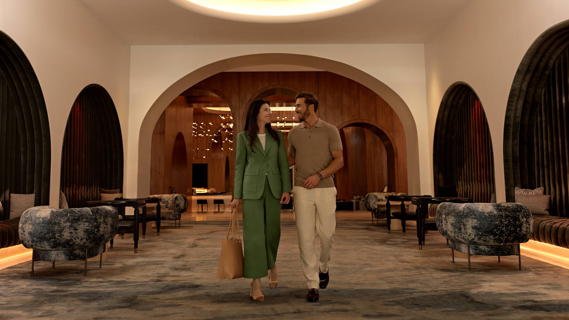 Man and woman walking through lobby area with comfortable seating