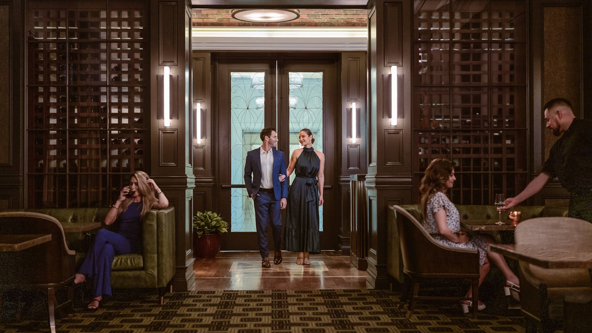 Man and woman walking arm in arm into restaurant area