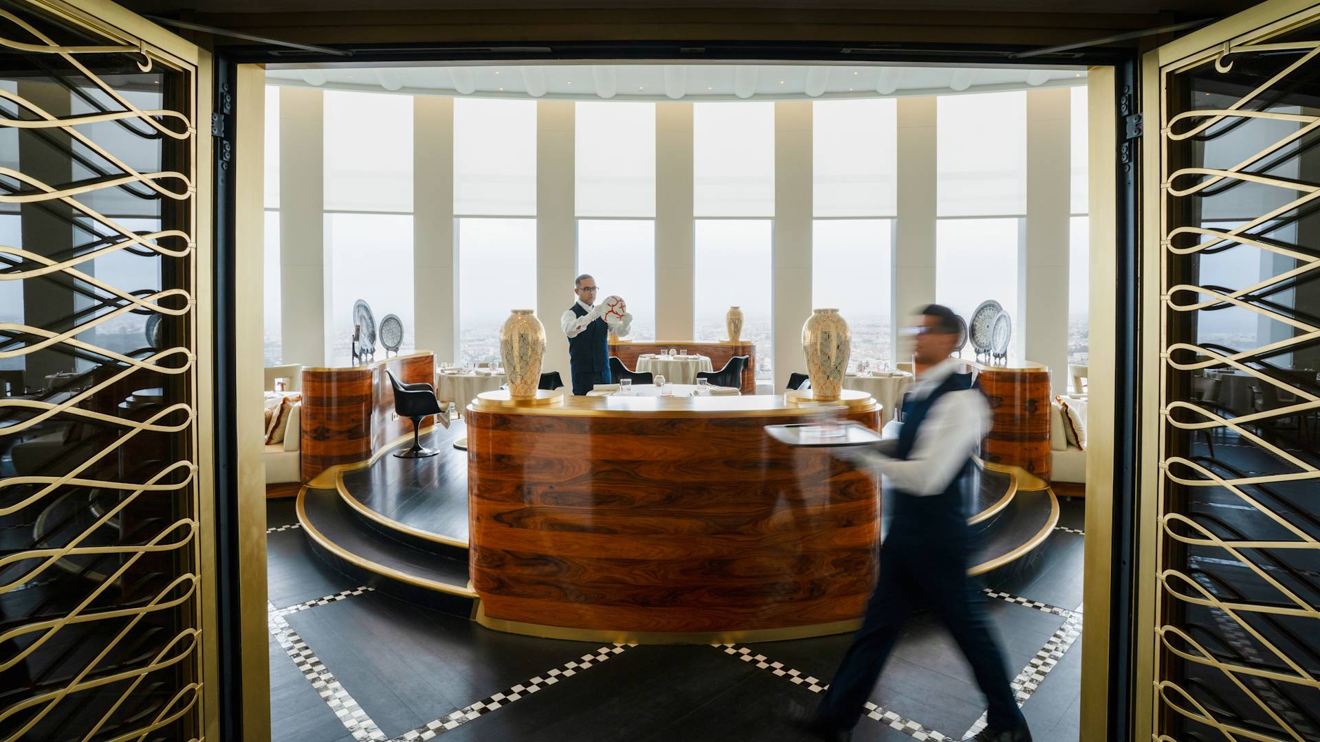 Le serveur porte un plateau au restaurant Aldabaran Alain Ducasse