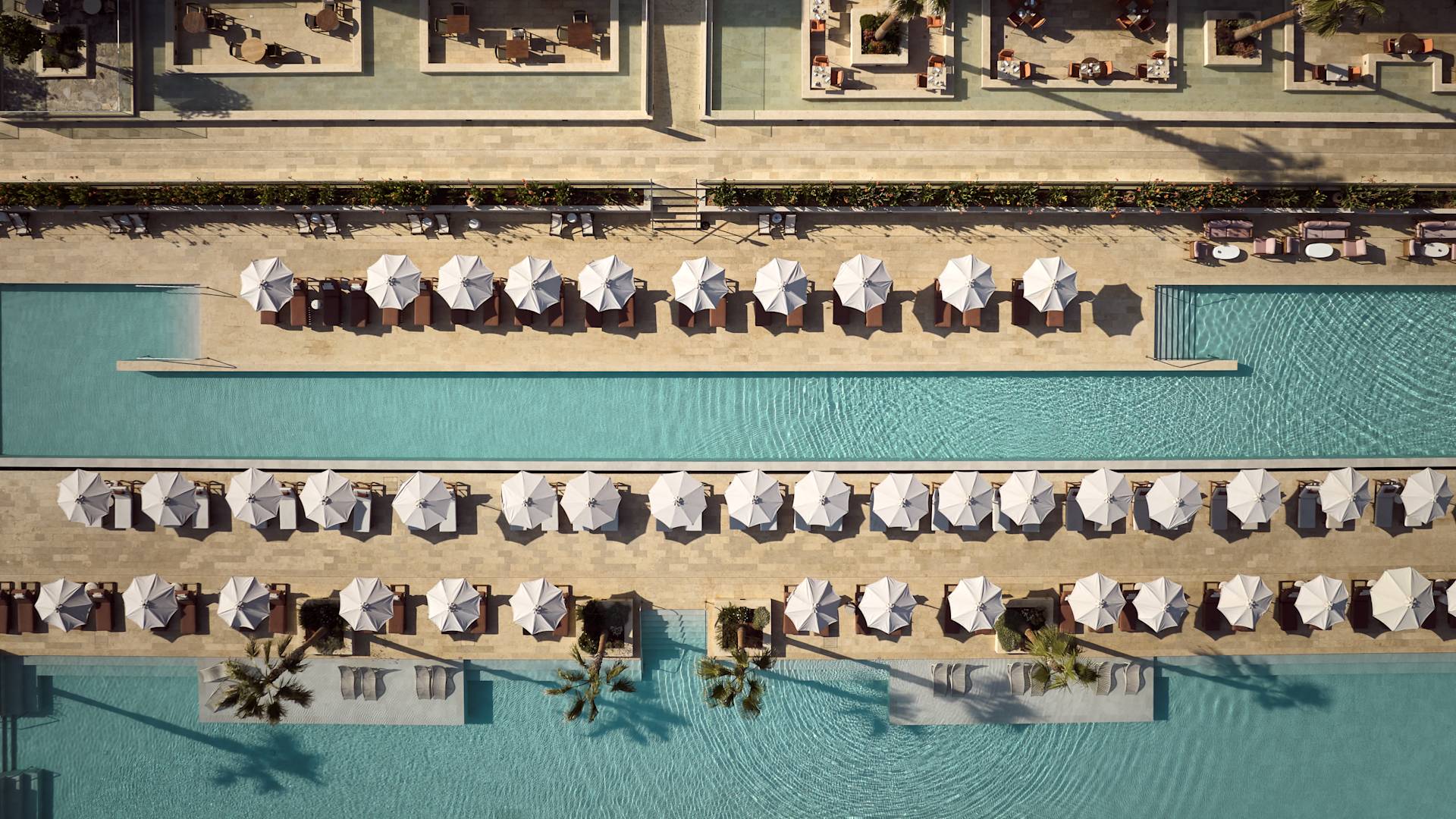 Outdoor Pool Area with Seats under Umbrellas