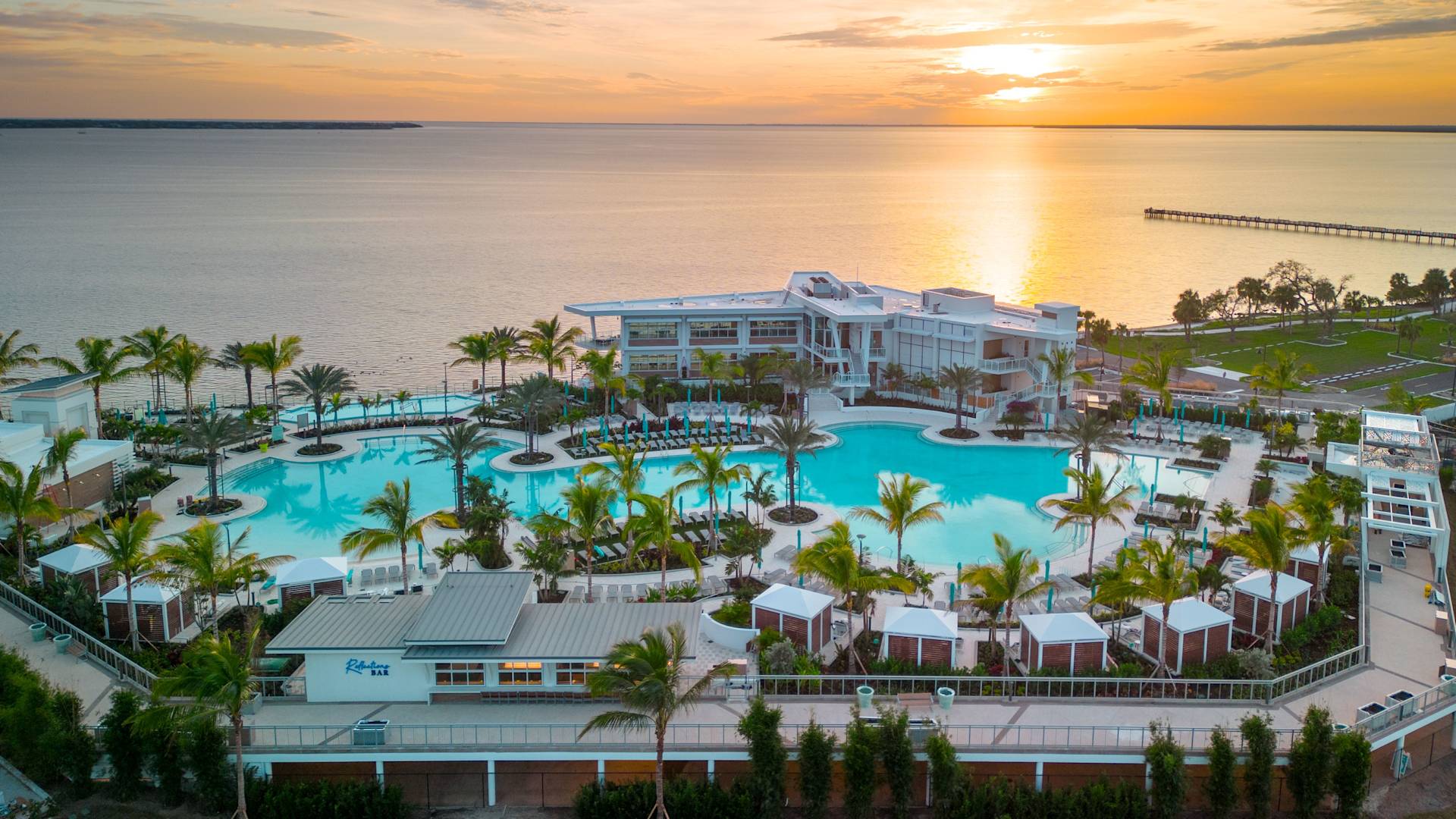 Outdoor Pool Area with Palm Trees at Sunset