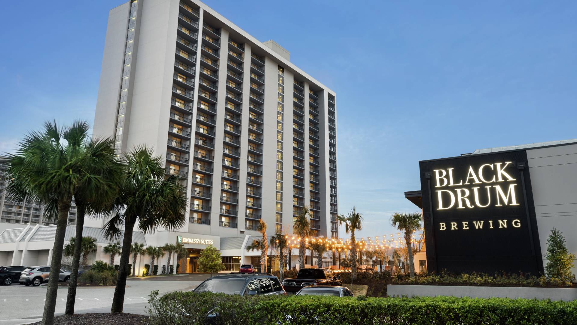 Modern hotel exterior featuring on-site brewery and restaurant.