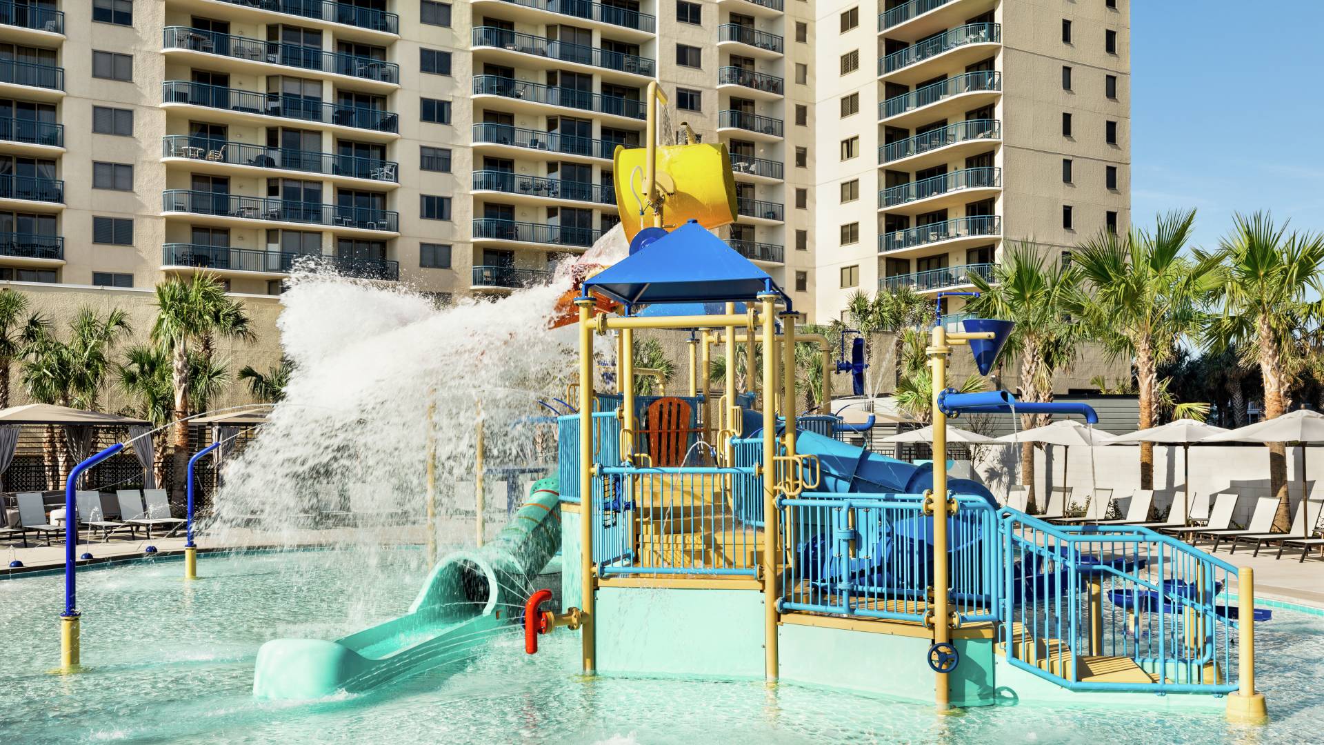Convenient outdoor kids splash area featuring waterslide