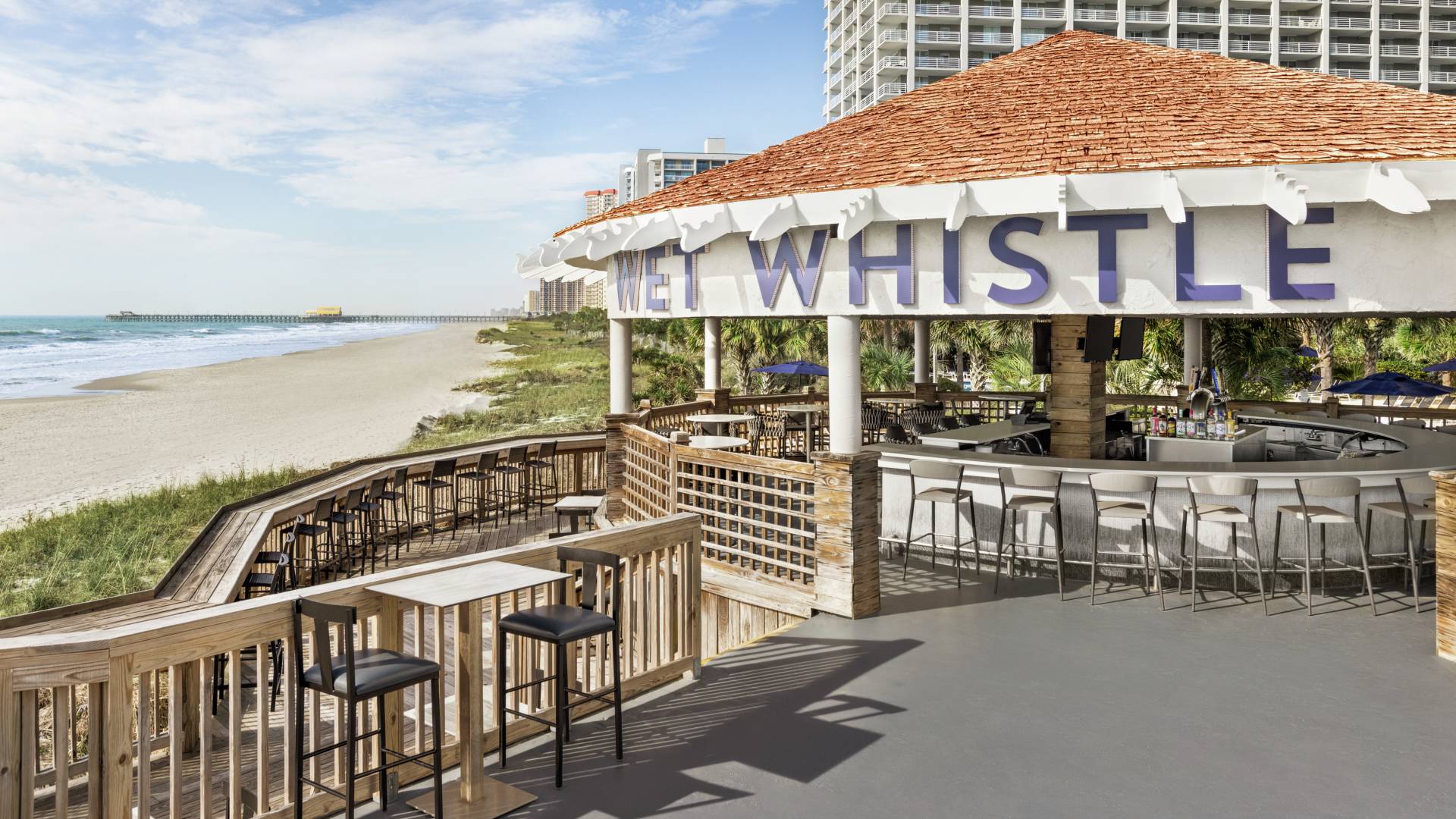 Beautiful oceanside hotel bar featuring ample seating for guests.