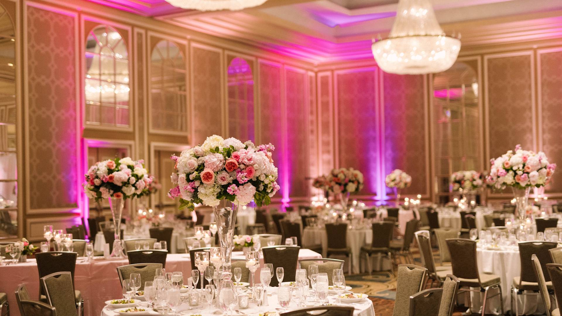 Ballroom Setup with Flowers and Round Tables to Celebrate a Wedding