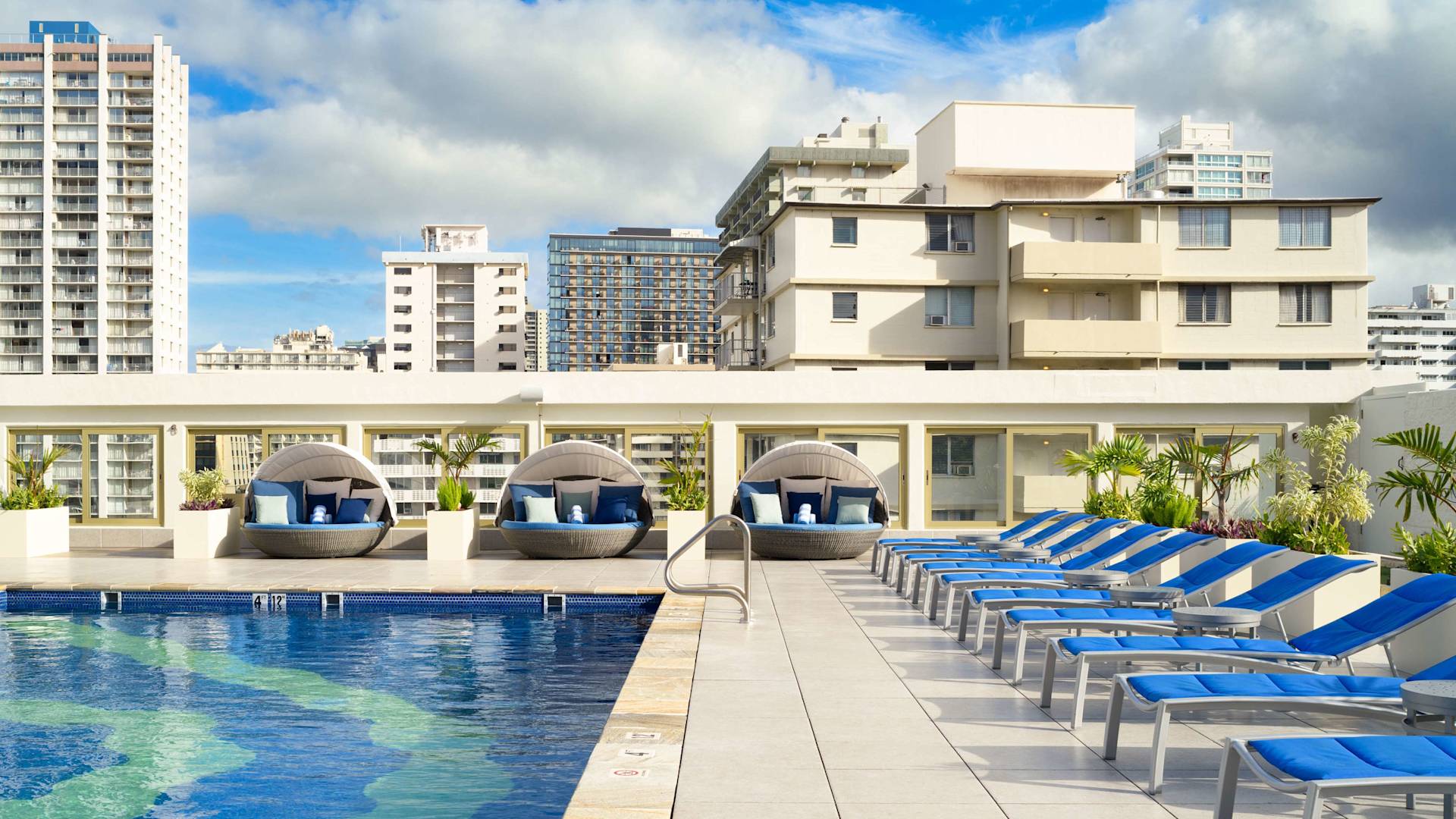 outdoor pool, lounge chairs, day beds