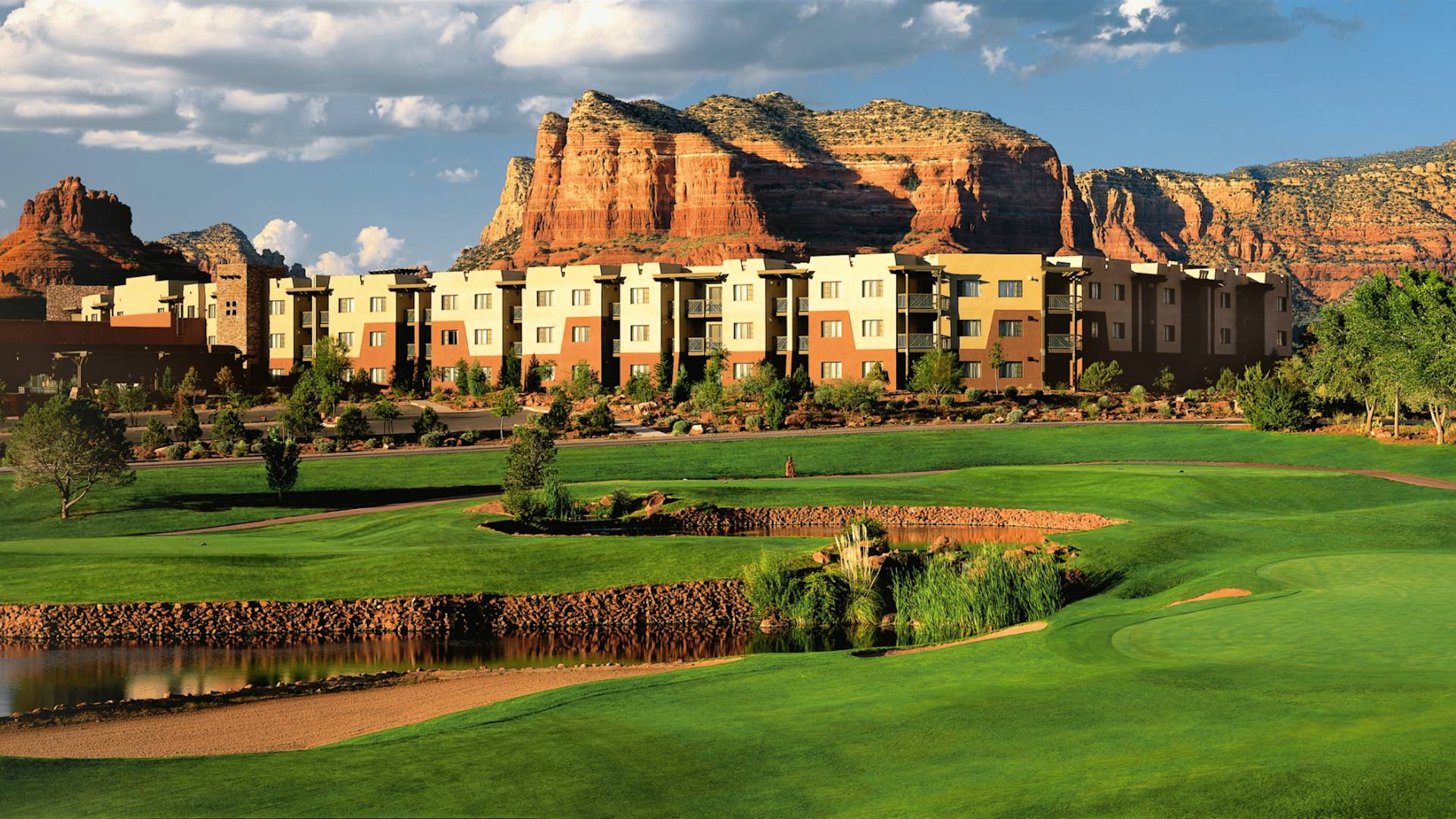 Hotel exterior with golf course and mountains