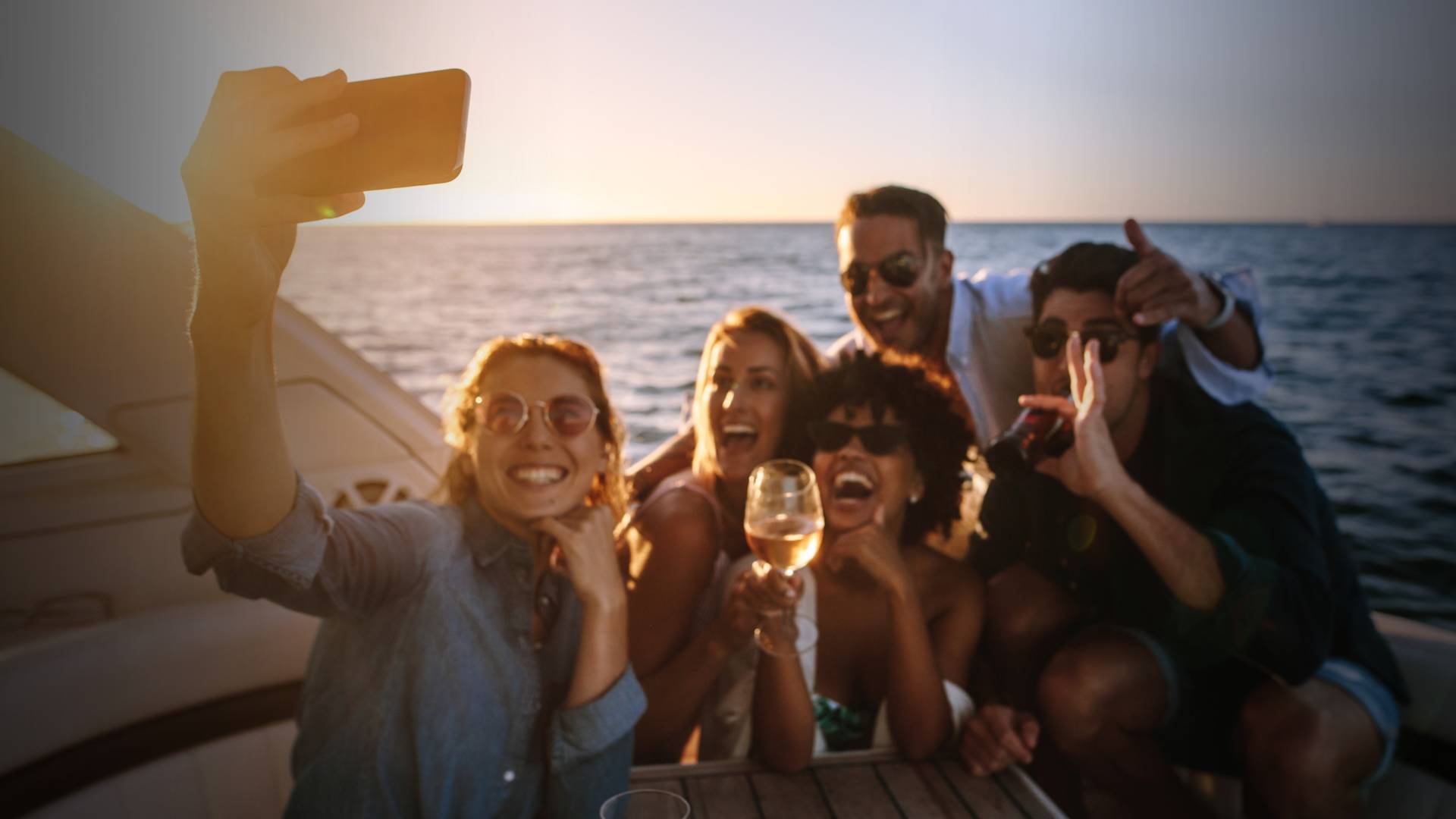 People taking group selfie on boat