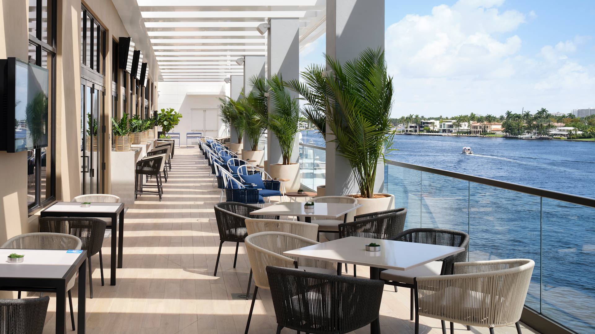 Restaurant seating area with tables and chairs by the sea