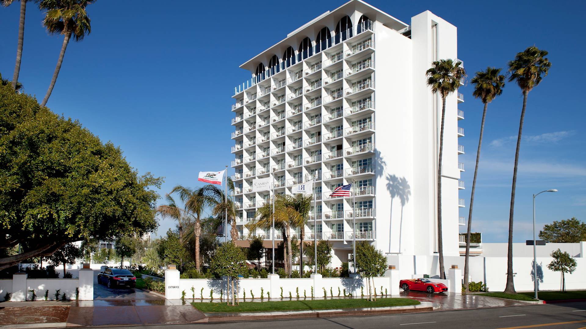 Hotel exterior with cars arriving