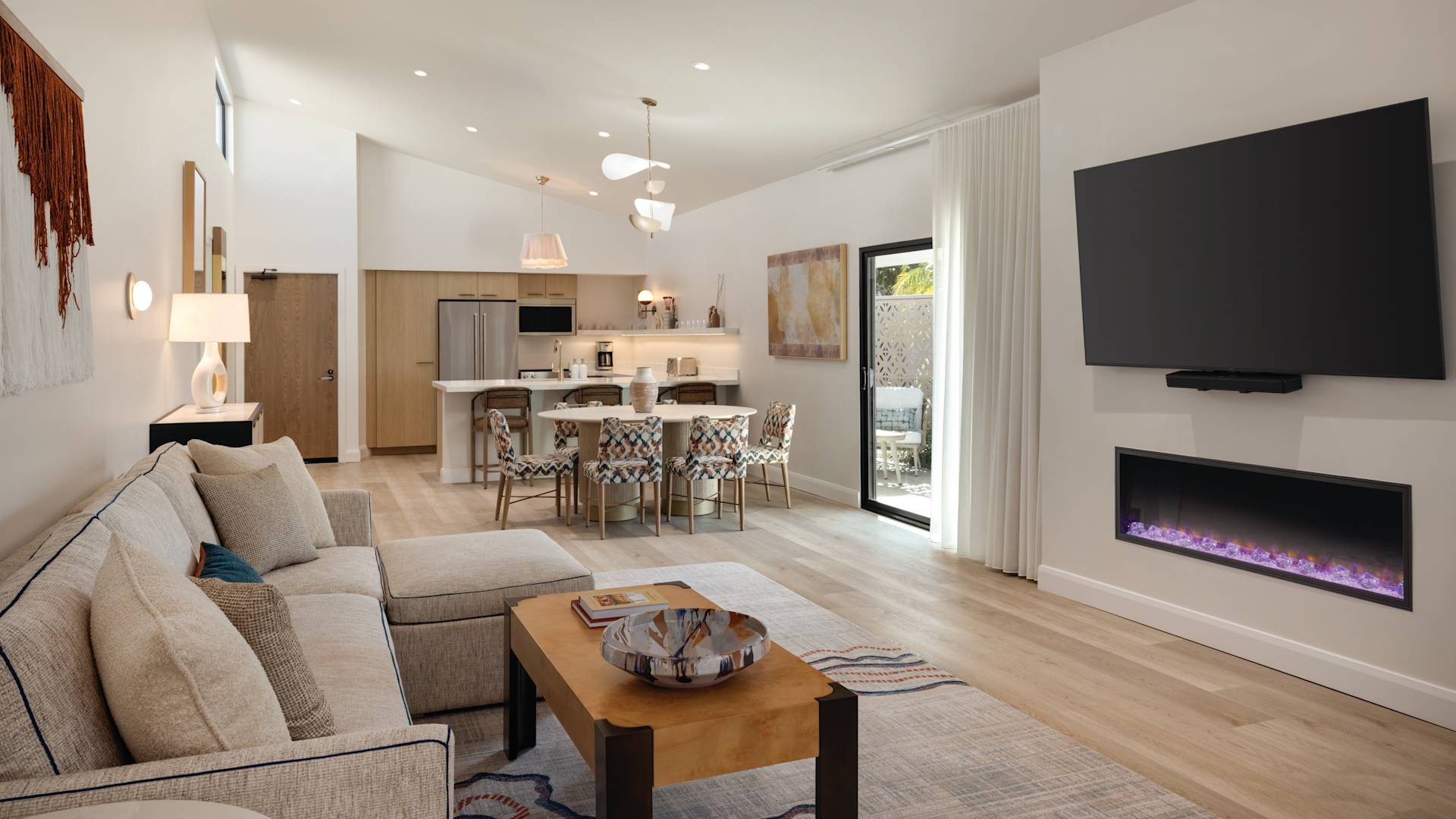 Suite living area with a fireplace, TV, and a full kitchen.